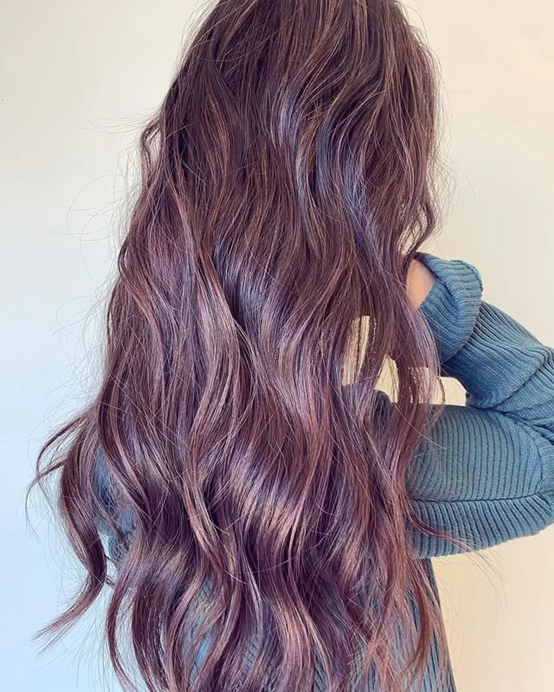 Long wavy hair with a layered cut and balayage color. 1