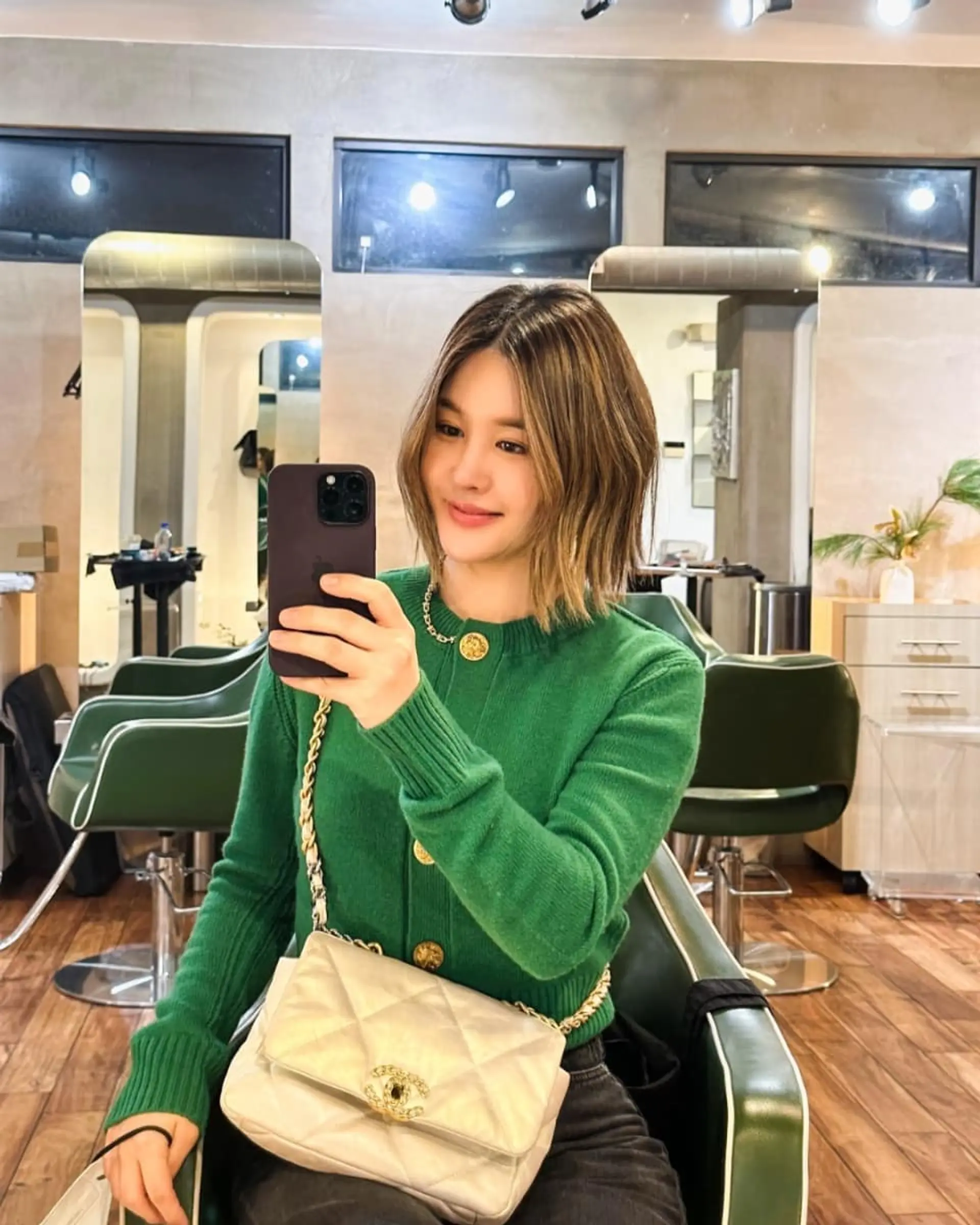 A textured chin-to-collarbone A-line bob cut with dimensional blonde highlights and a darker root. 1