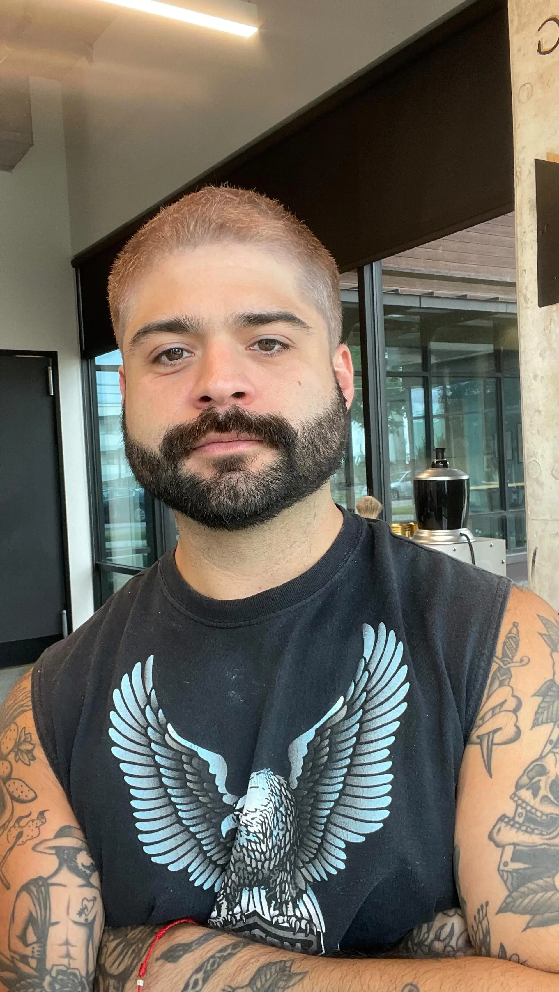 A short buzz cut dyed in a soft rose gold blonde shade. 1