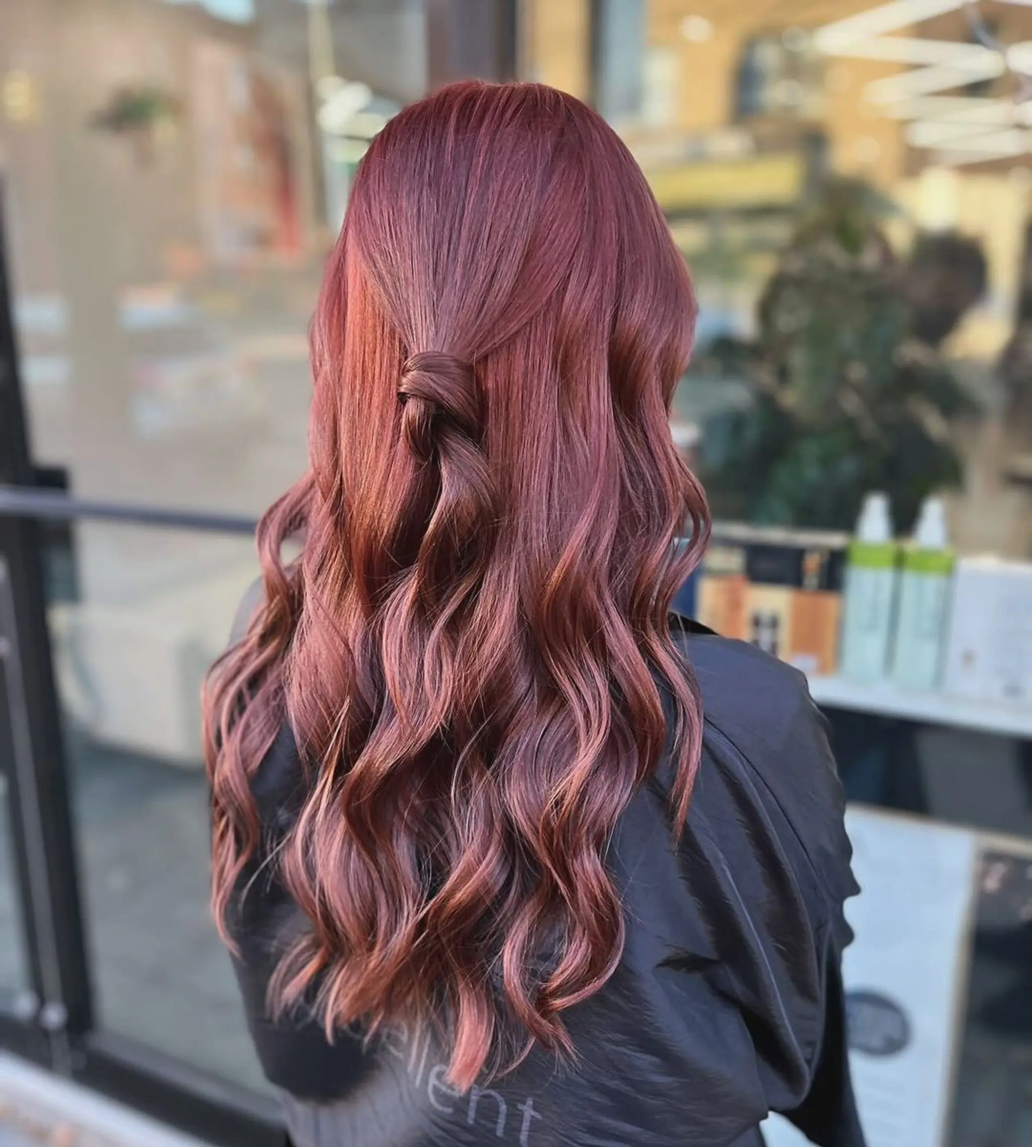 Long, wavy hair in a copper and auburn blend, styled with a half-up knot and loose waves cascading down.
Stylist - @xcellent_jason