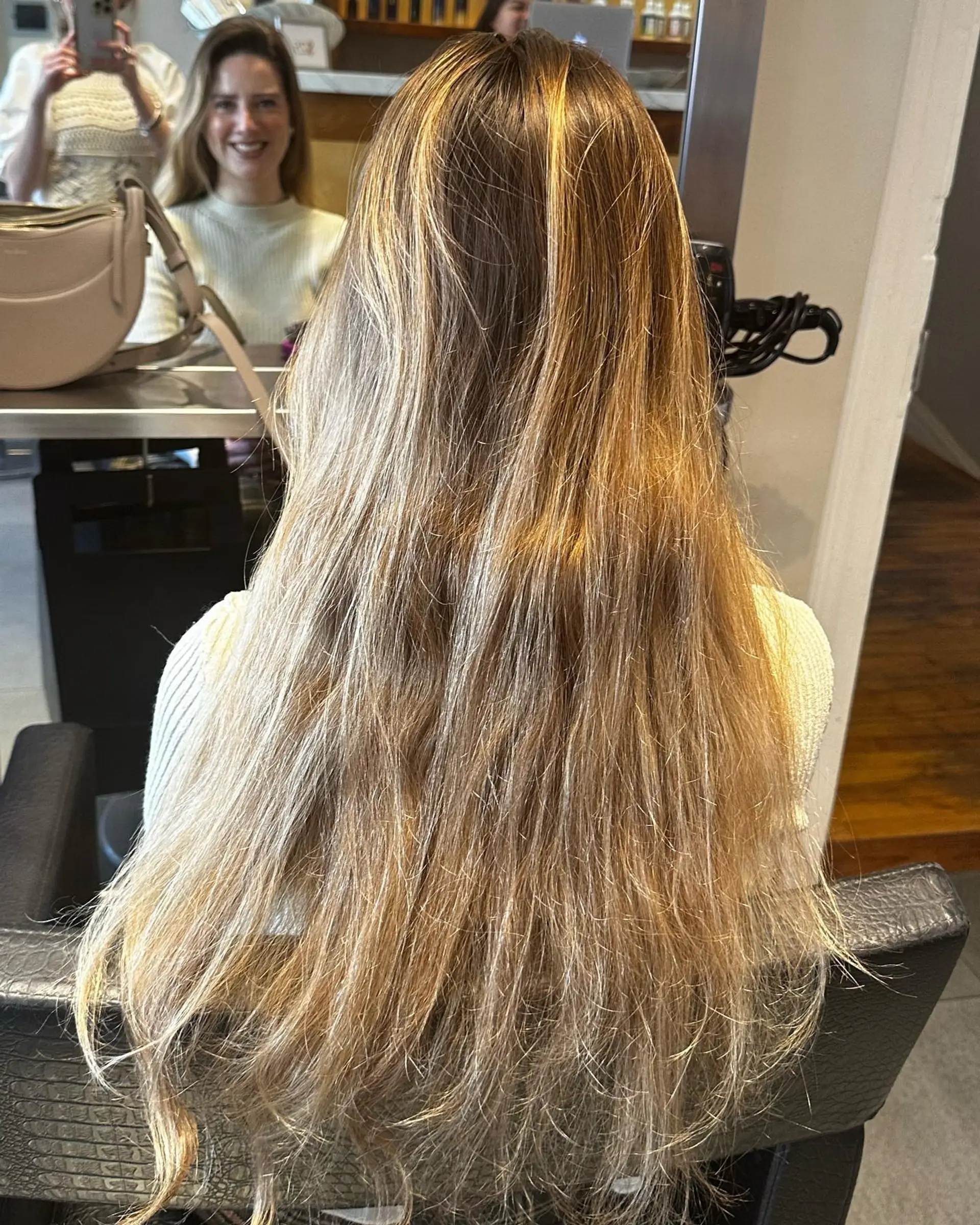 Very long straight hair featuring warm honey blonde highlights blended throughout a light brown base. 1
