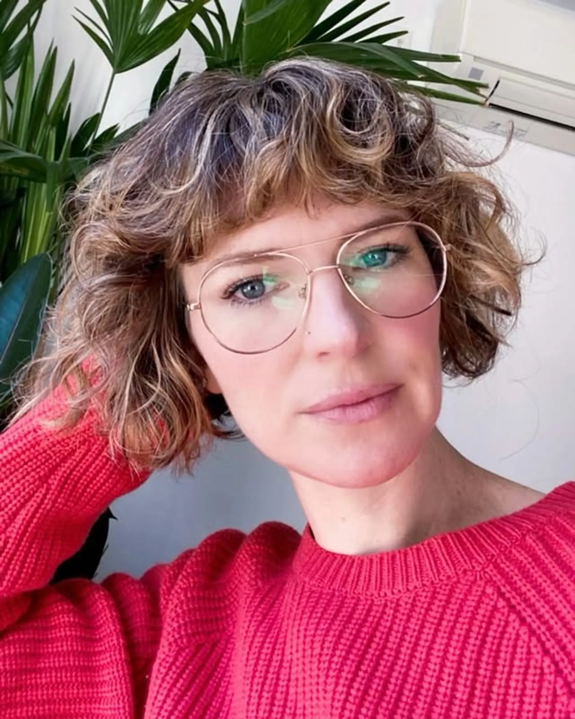 A textured, short curly bob with bangs. 1