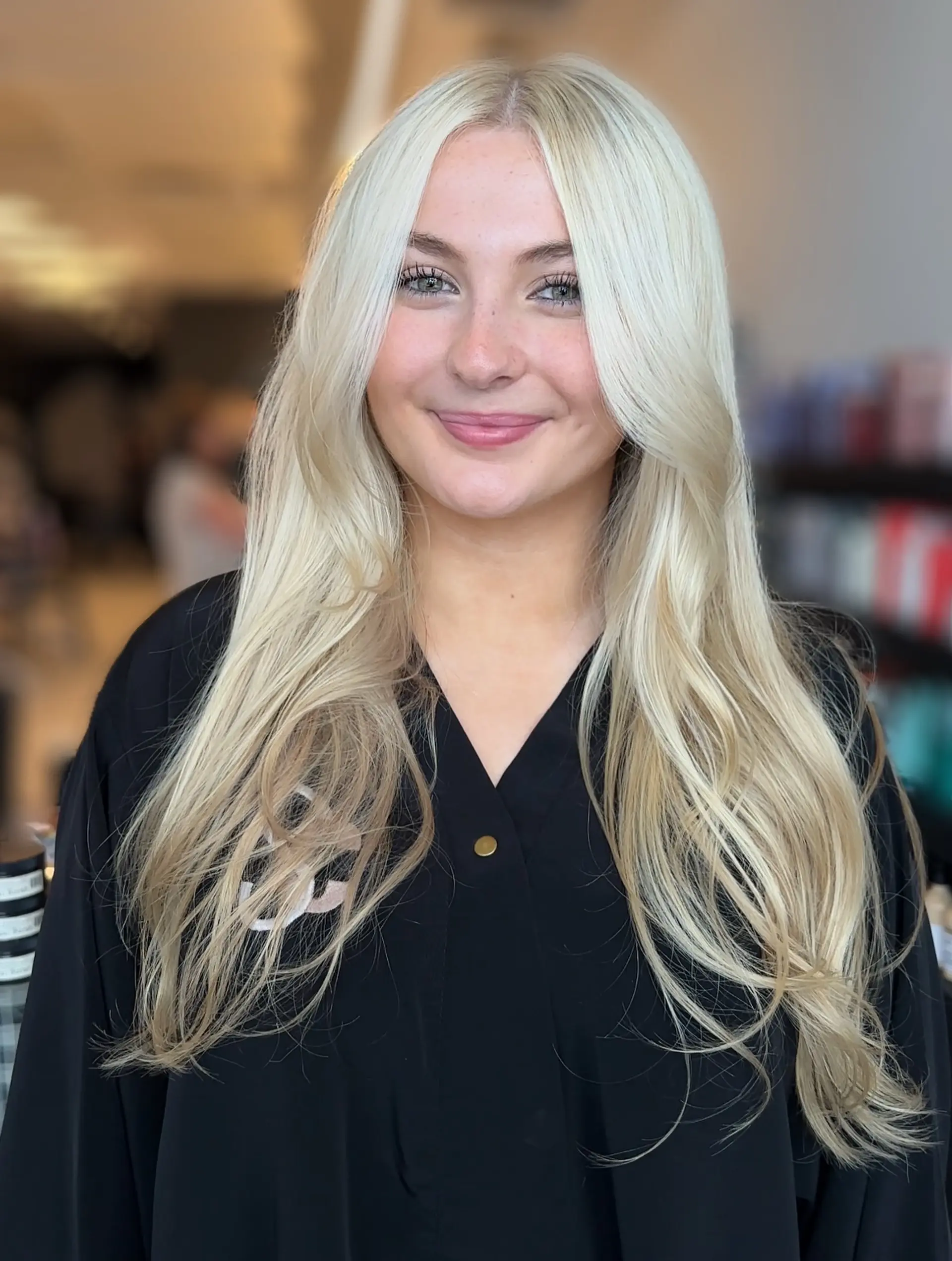 Bright platinum blonde long hair styled with face-framing curtain bangs and soft, blown-out ends. 1