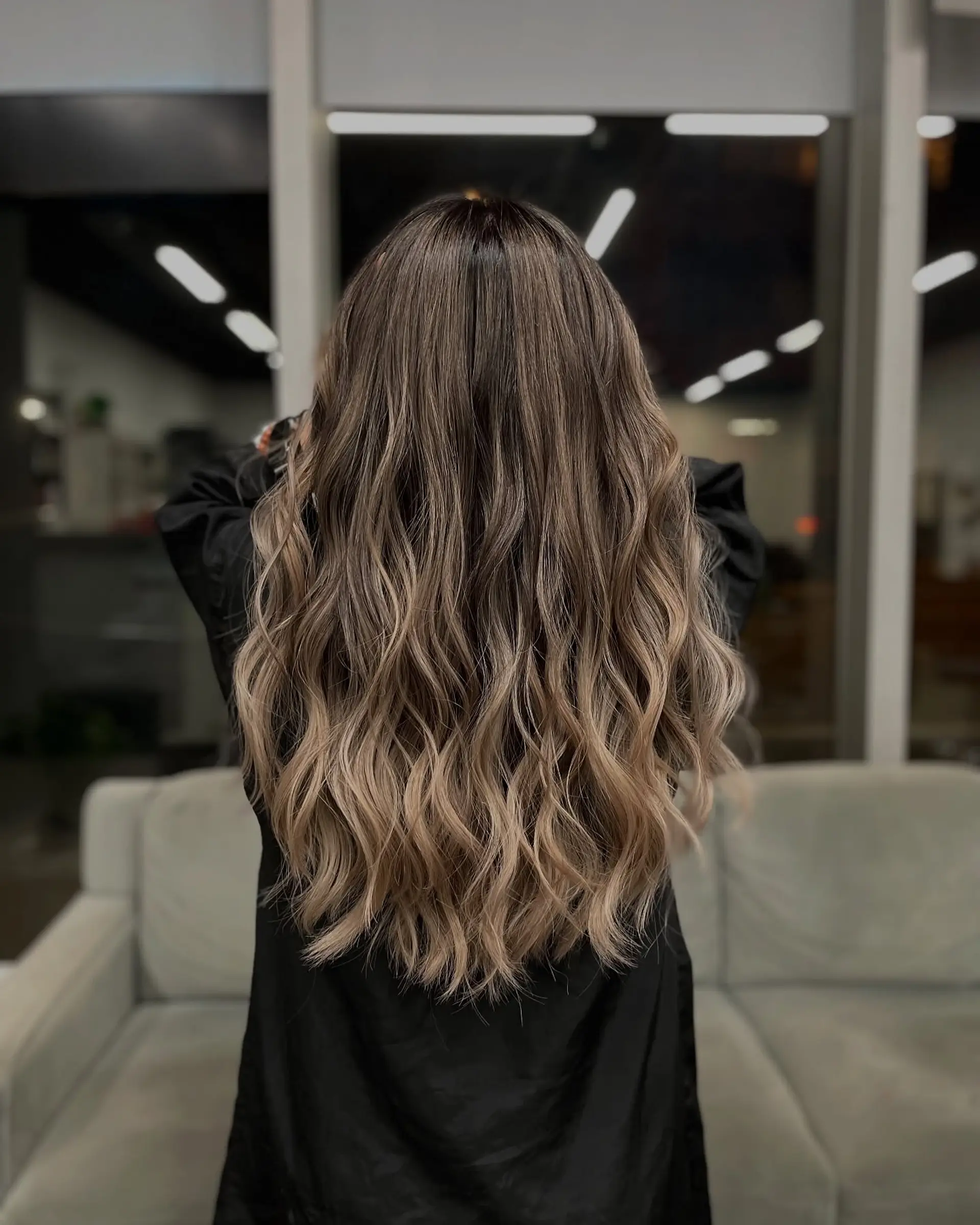 A very long wavy hairstyle with an ombre color effect. 1