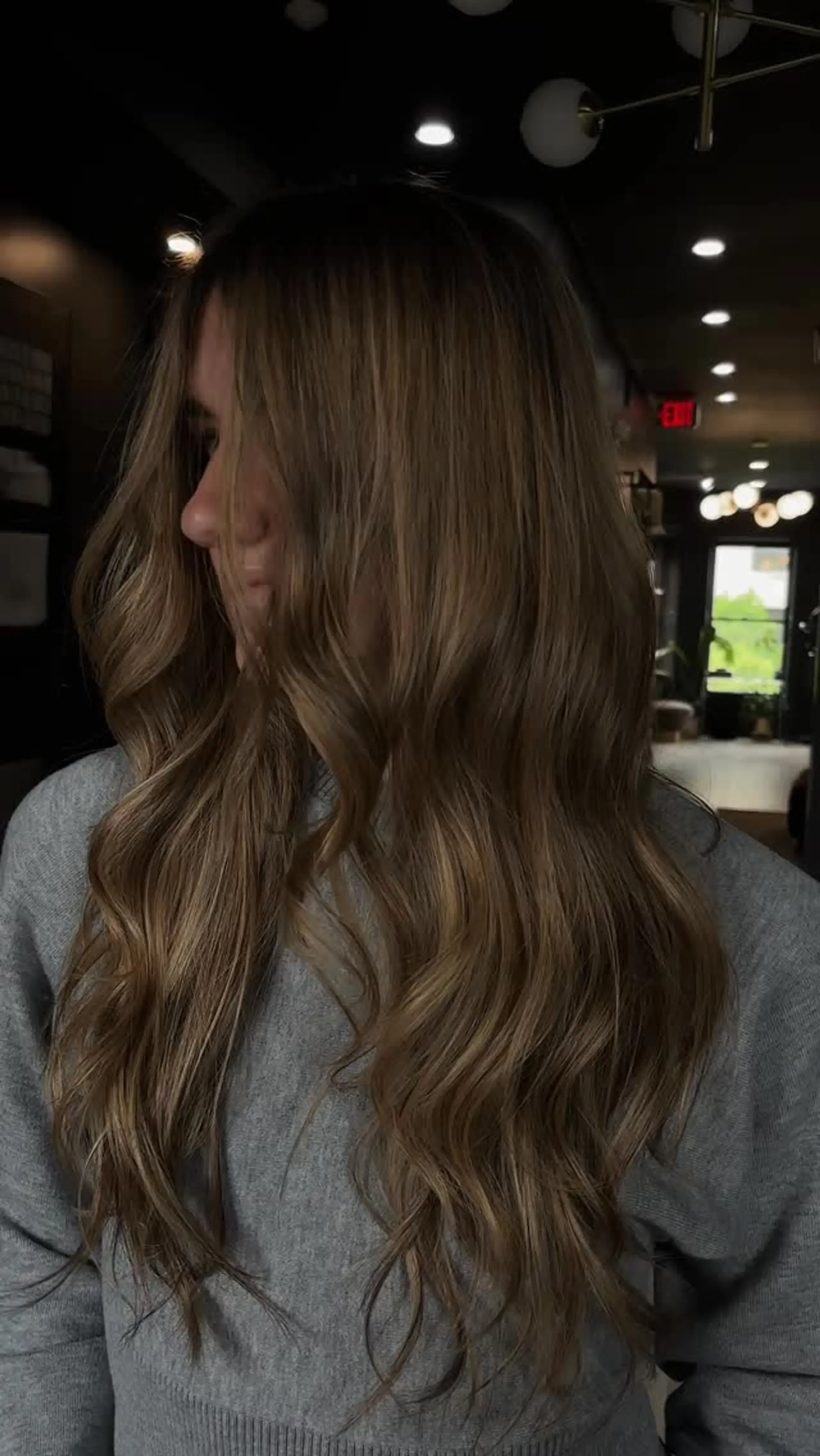 Long bronde hair featuring soft, cascading waves and seamless dimensional highlights. 1
