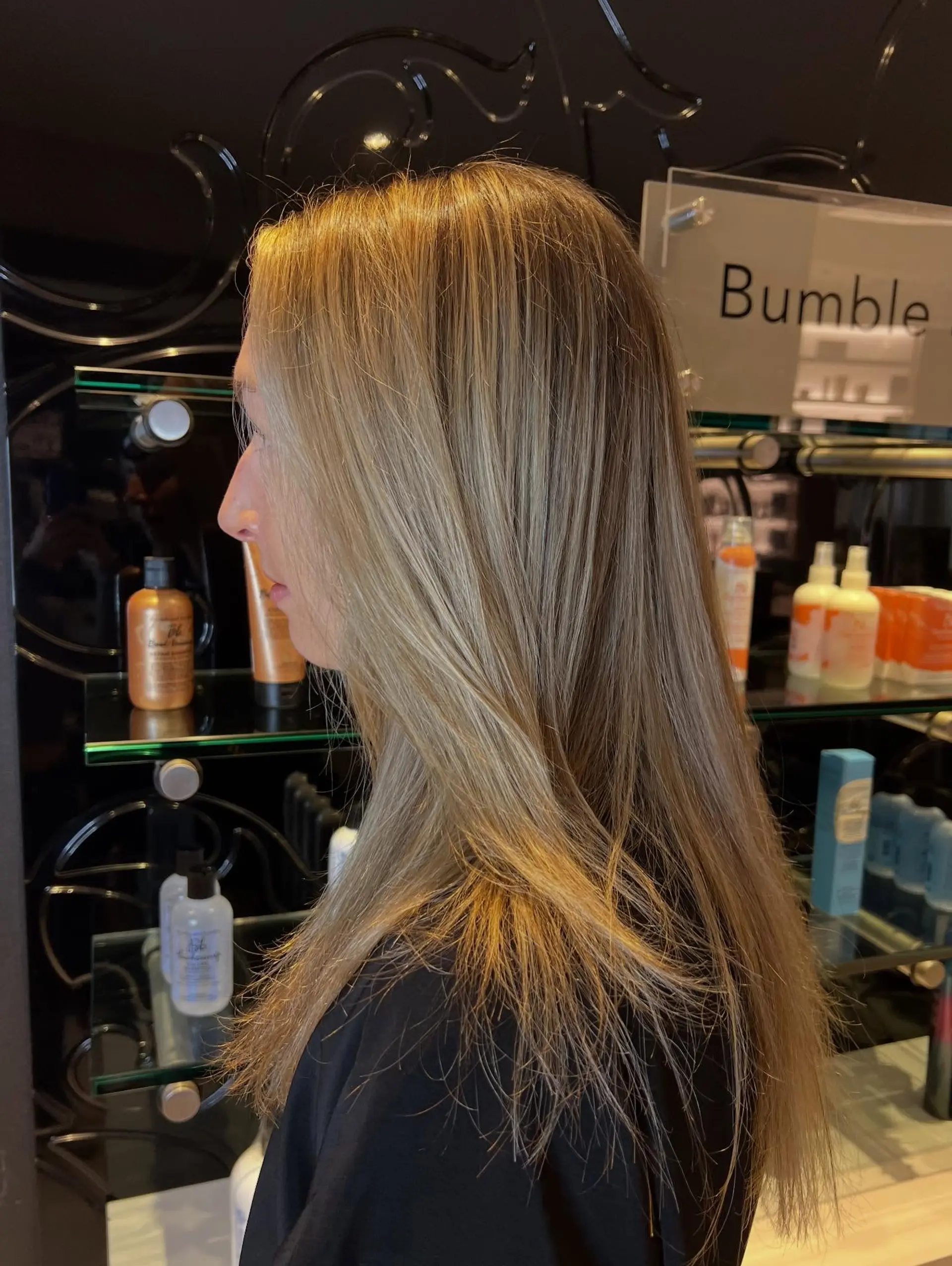 Long straight hair featuring a blended, soft blonde balayage over a natural dark blonde base. 1