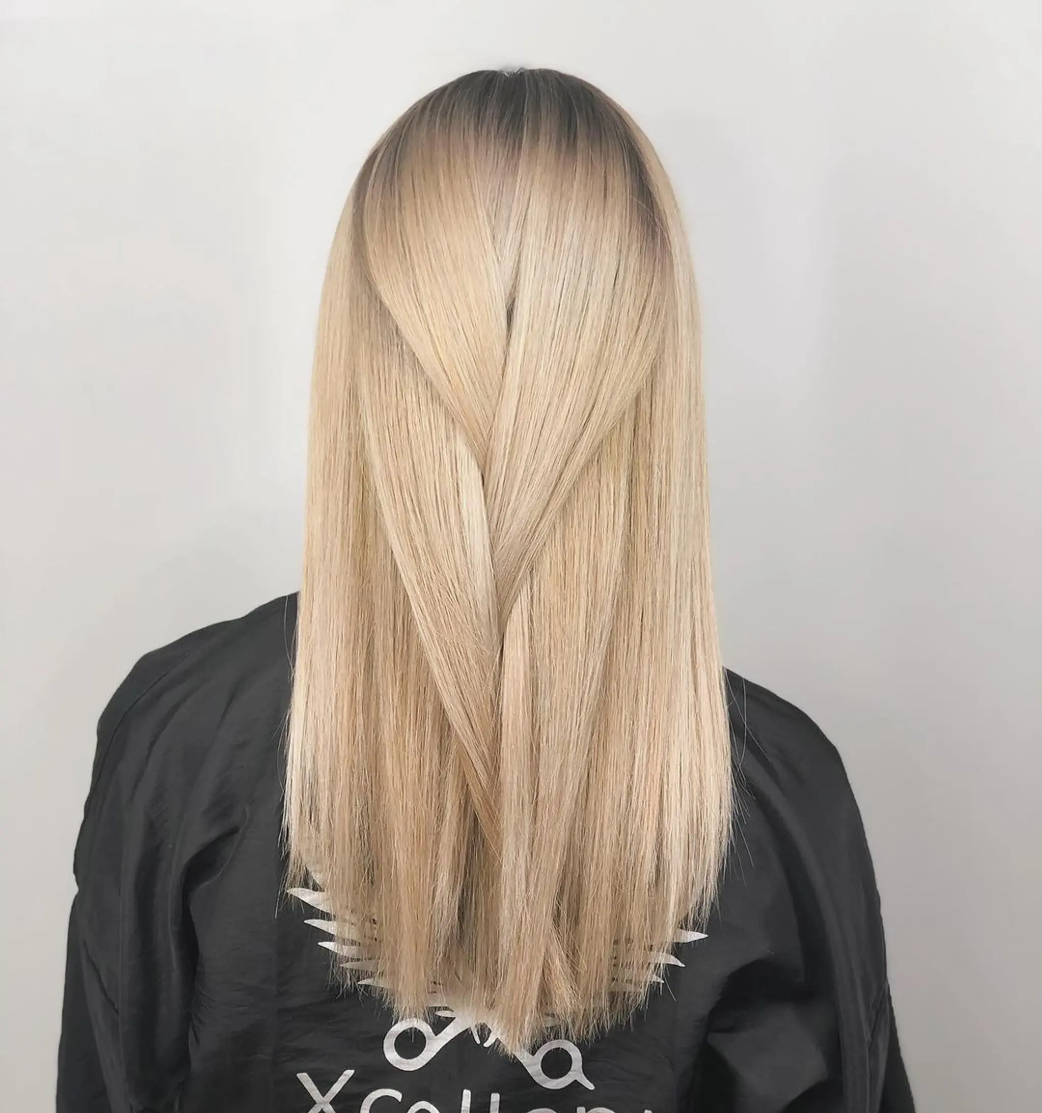 A long, straight, layered hairstyle with a blend of platinum and golden blonde hues, finished with a polished and smooth appearance.
Stylist - @xcellent_jason
