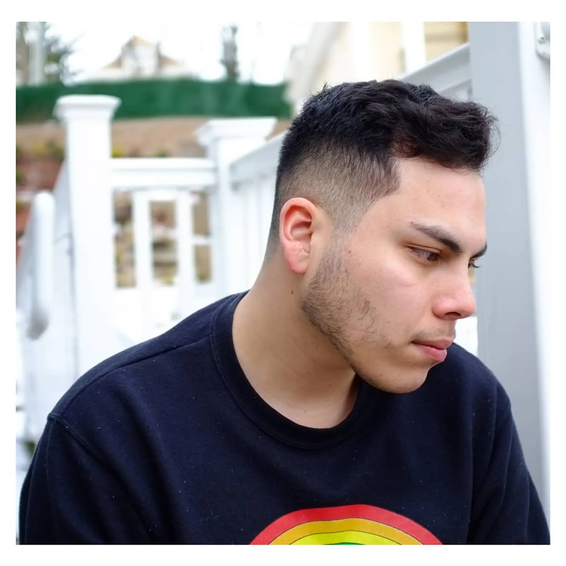 A sharp men's cut featuring a clean mid-to-high skin fade along the sides and back, paired with textured length on top. 1