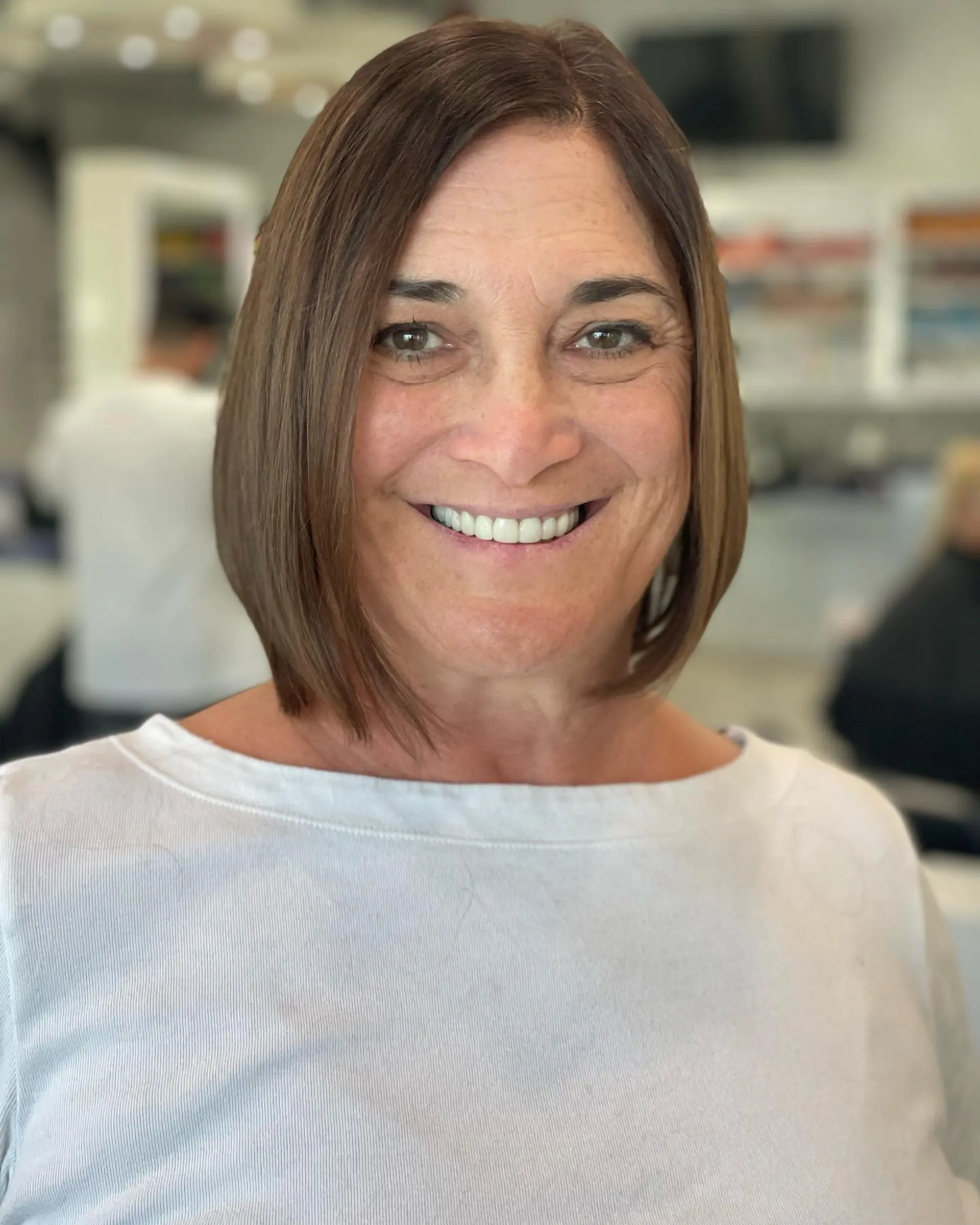 A timeless chin-length bob cut with straight styling. 1