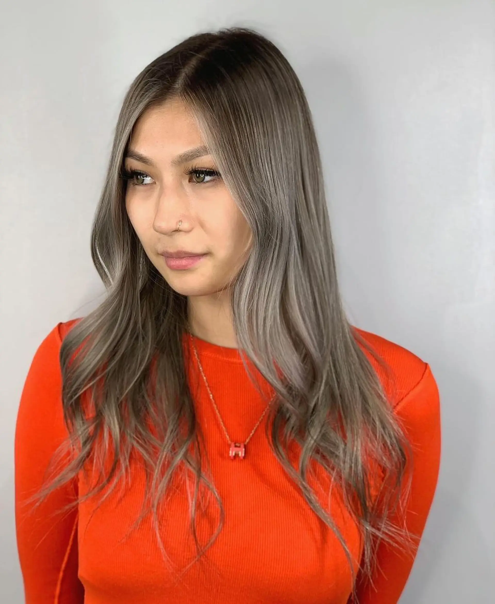 Long, wavy hair with a center part, face-framing layers, natural shine, soft waves, and a subtle ombre effect in silver and platinum tones.
Stylist - @xcellent_jason 1