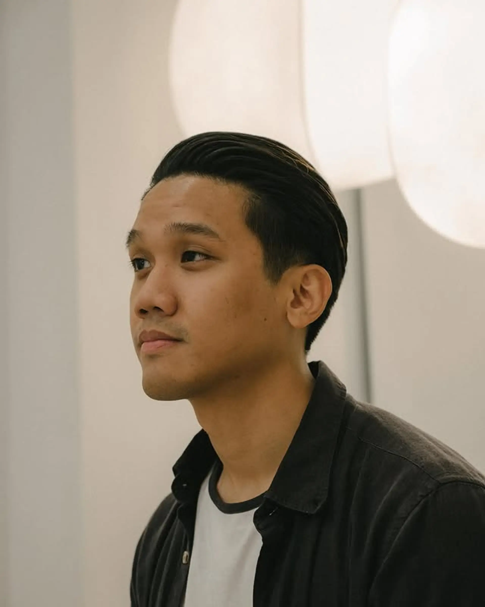 A sleek, slicked back pompadour with a clean and polished finish. 1