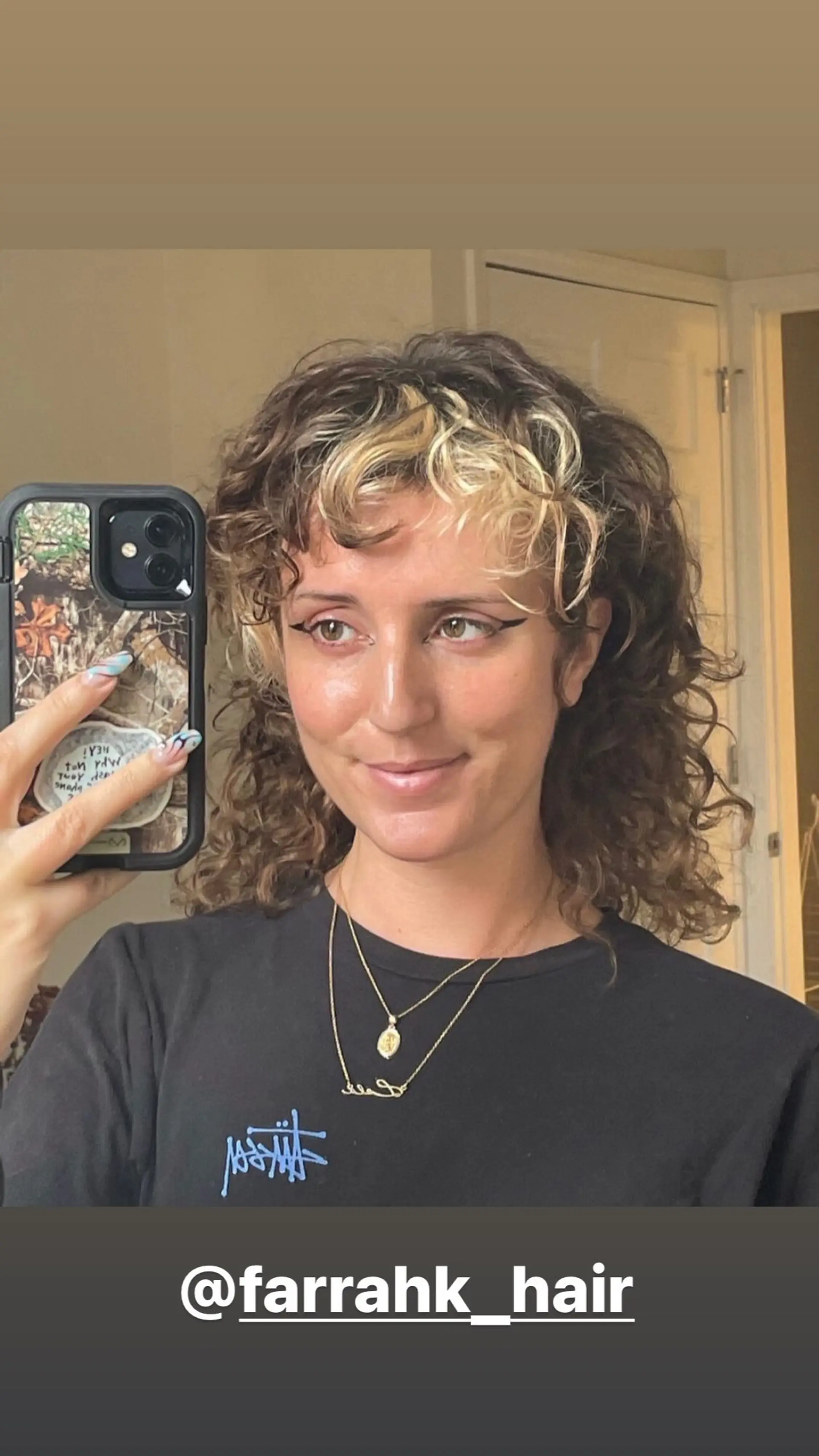 A shaggy, layered wolf cut with curly hair and blonde money piece highlights. 1