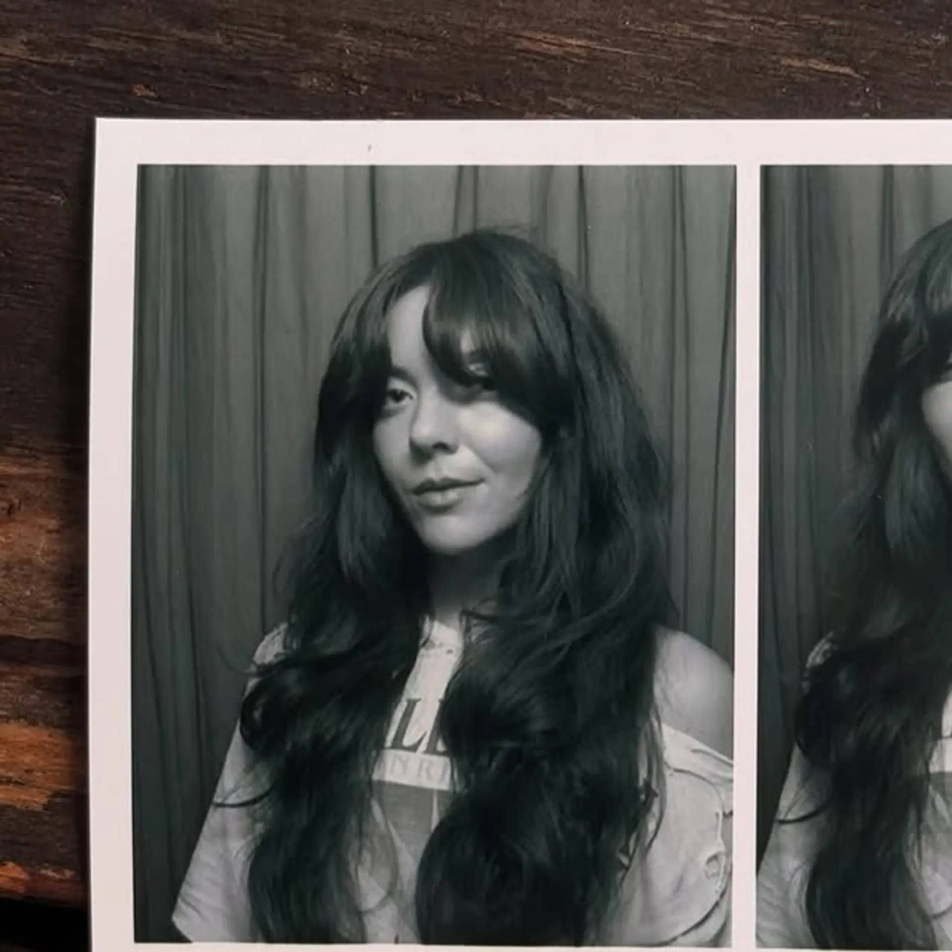 A long, wavy shaggy cut with center-parted curtain bangs. 1