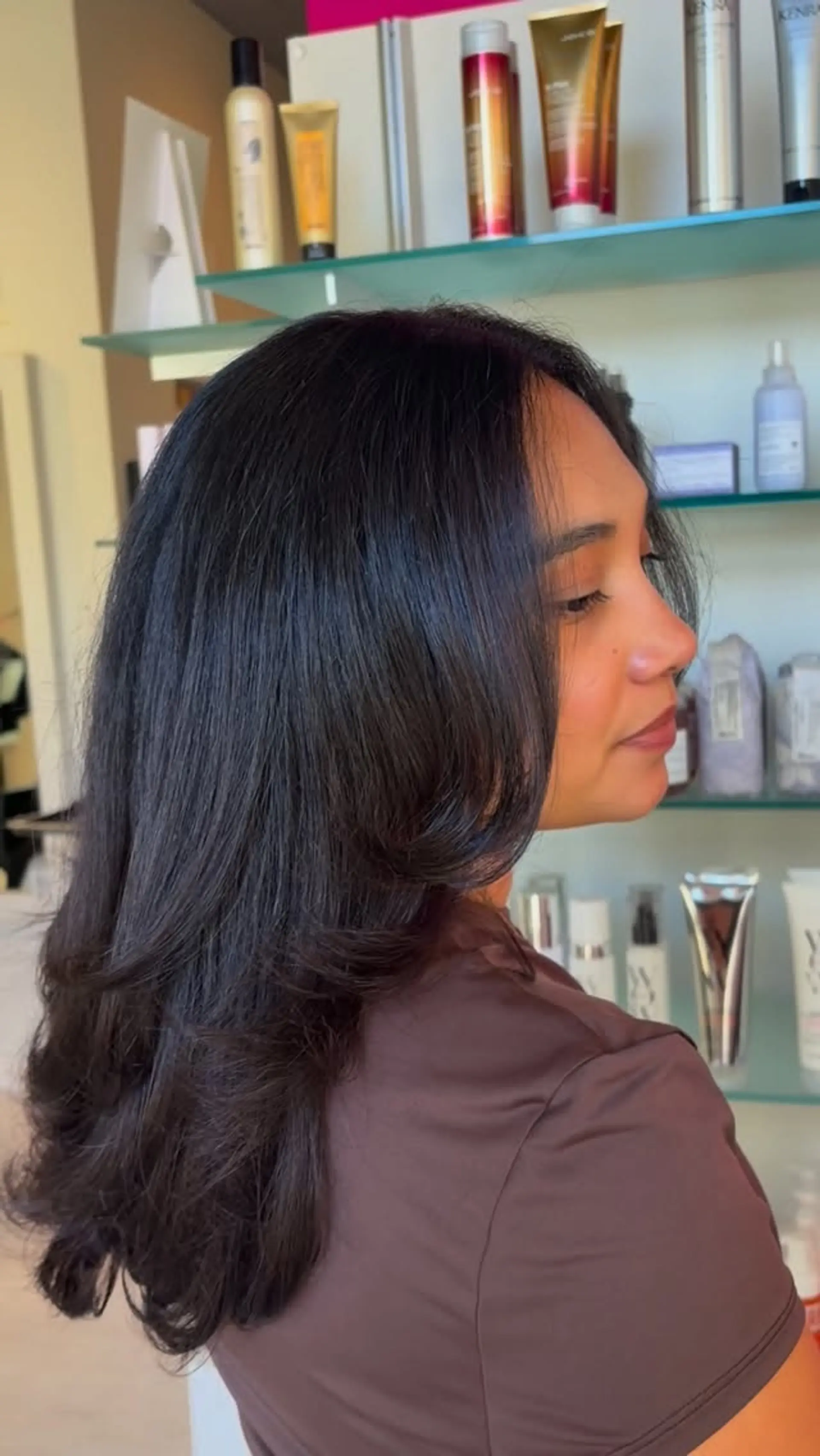 Long layered dark hair styled with a voluminous blowout and soft face-framing layers. 1