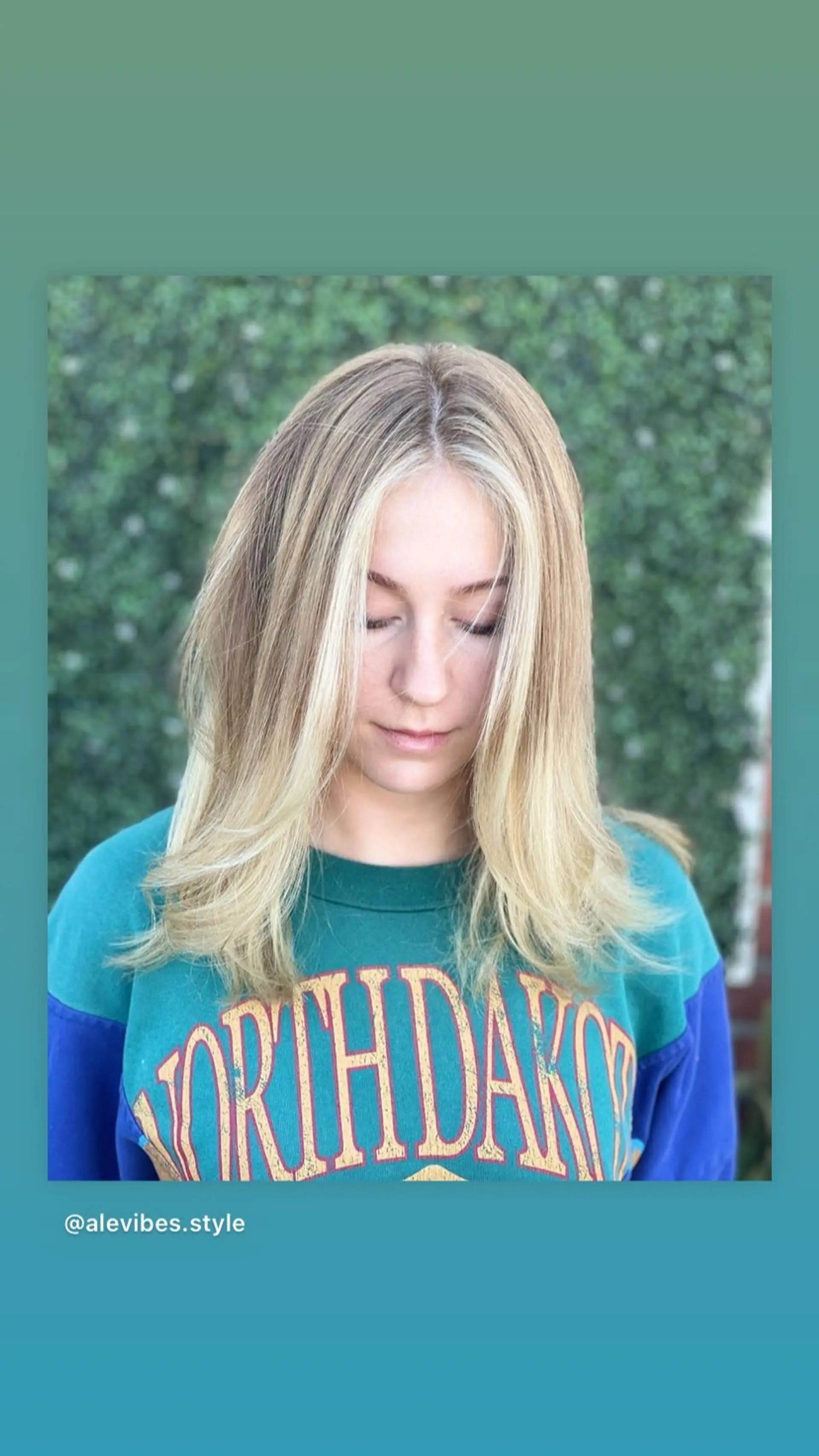 A medium length layered hairstyle with face-framing 'money piece' highlights. 1