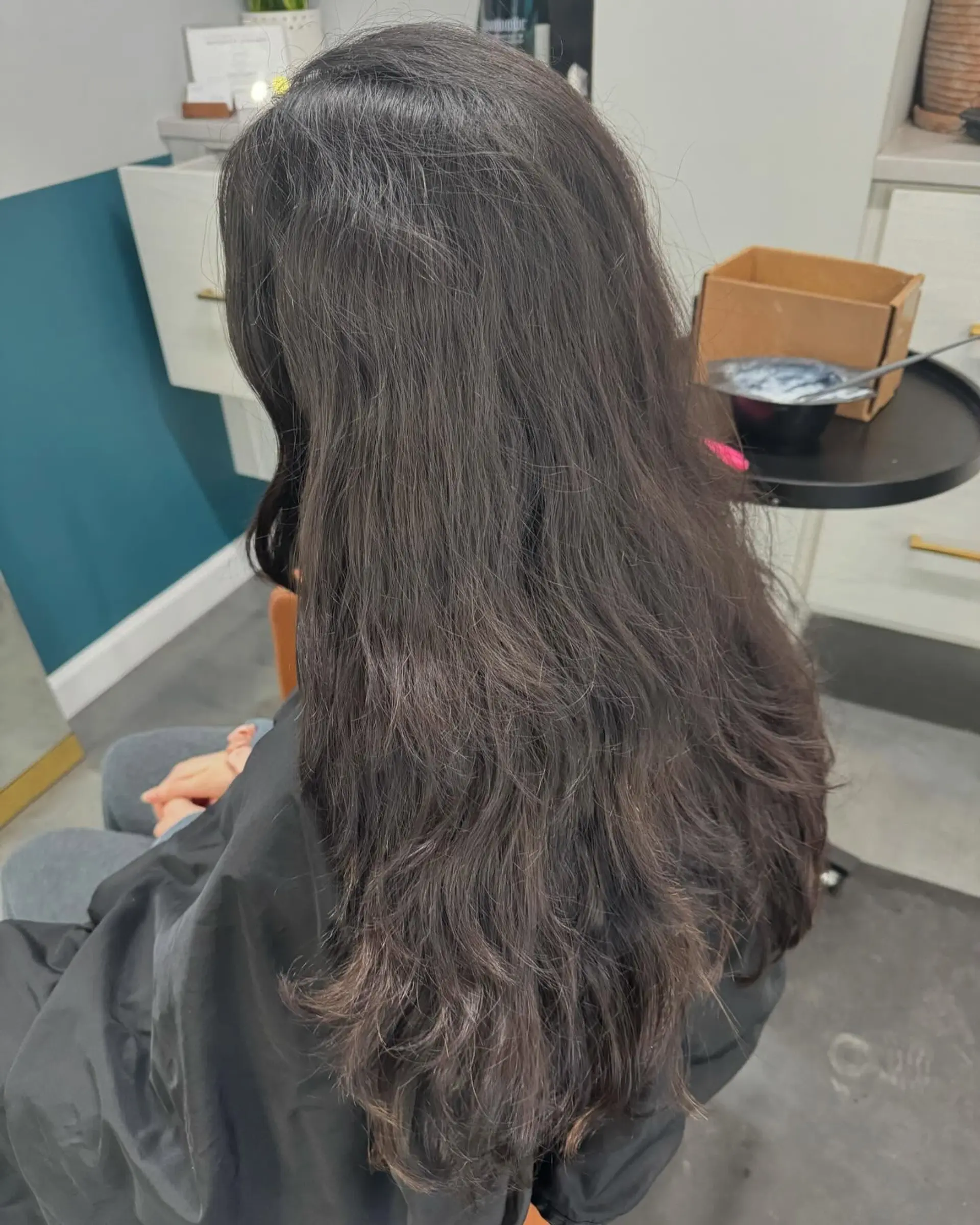 A long straight hairstyle with long layers and copper highlights. 2