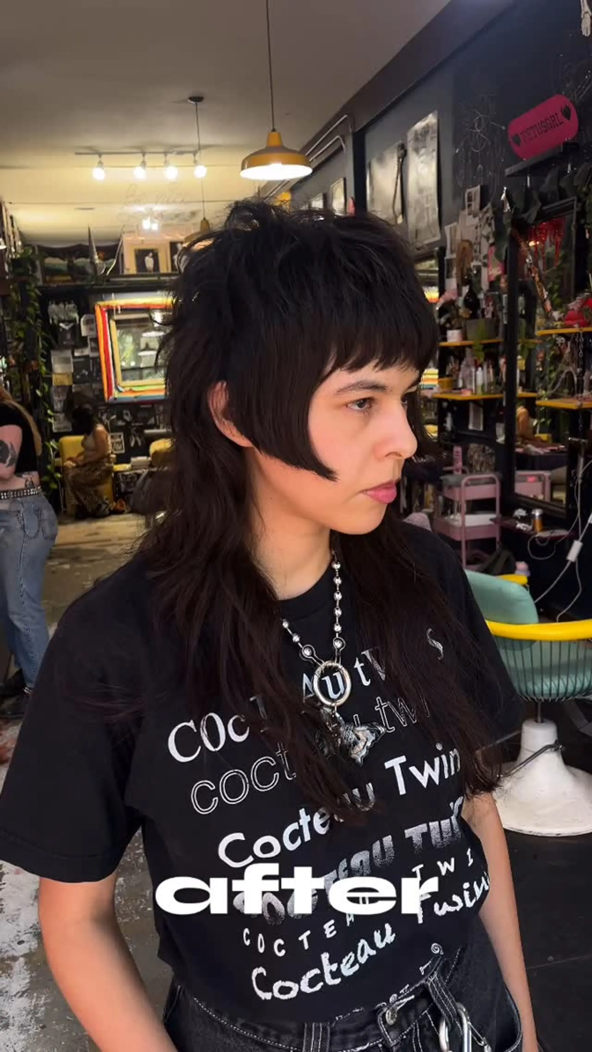 A dark, heavily layered shag mullet featuring micro bangs, blunt cheek-length face-framing pieces, and textured long layers. 1