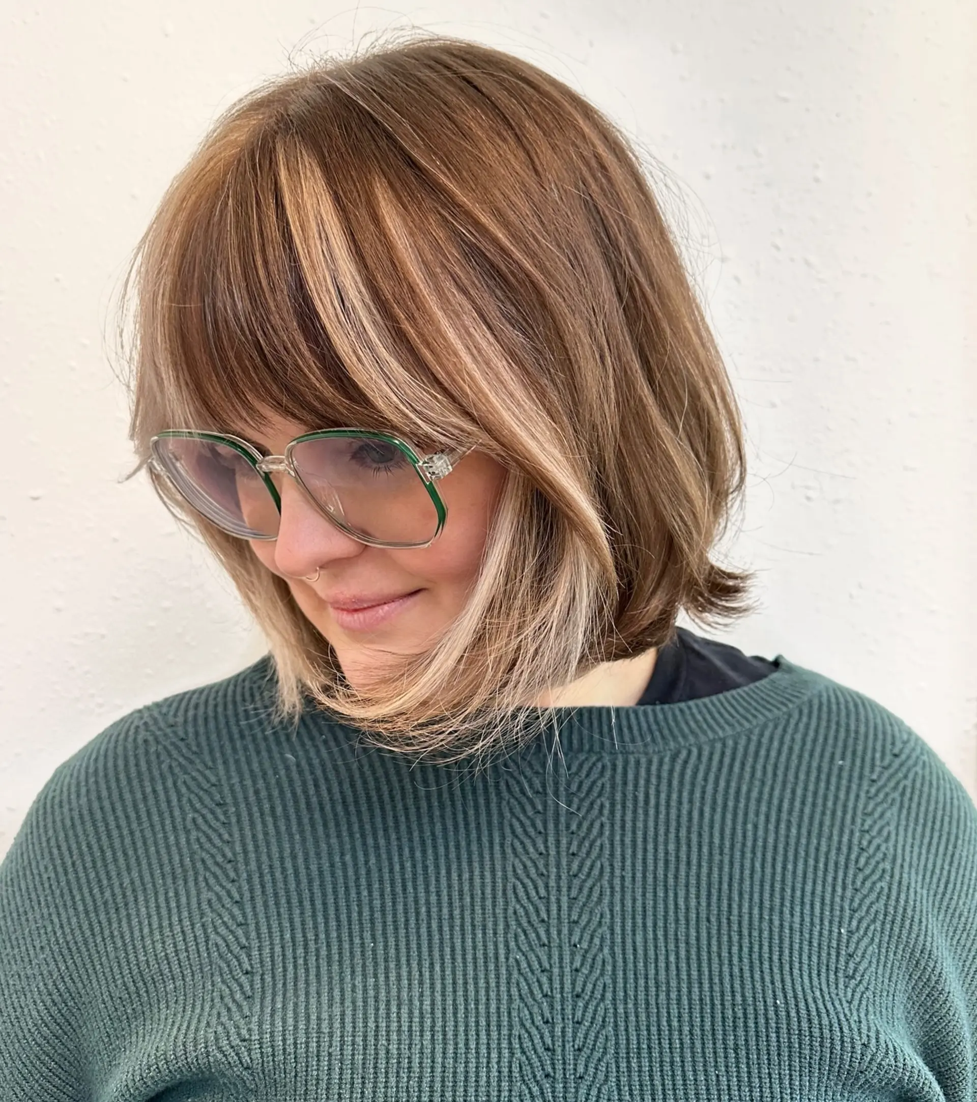A textured chin-length Italian bob with wispy bangs and blonde color-blocked framing accents. 1