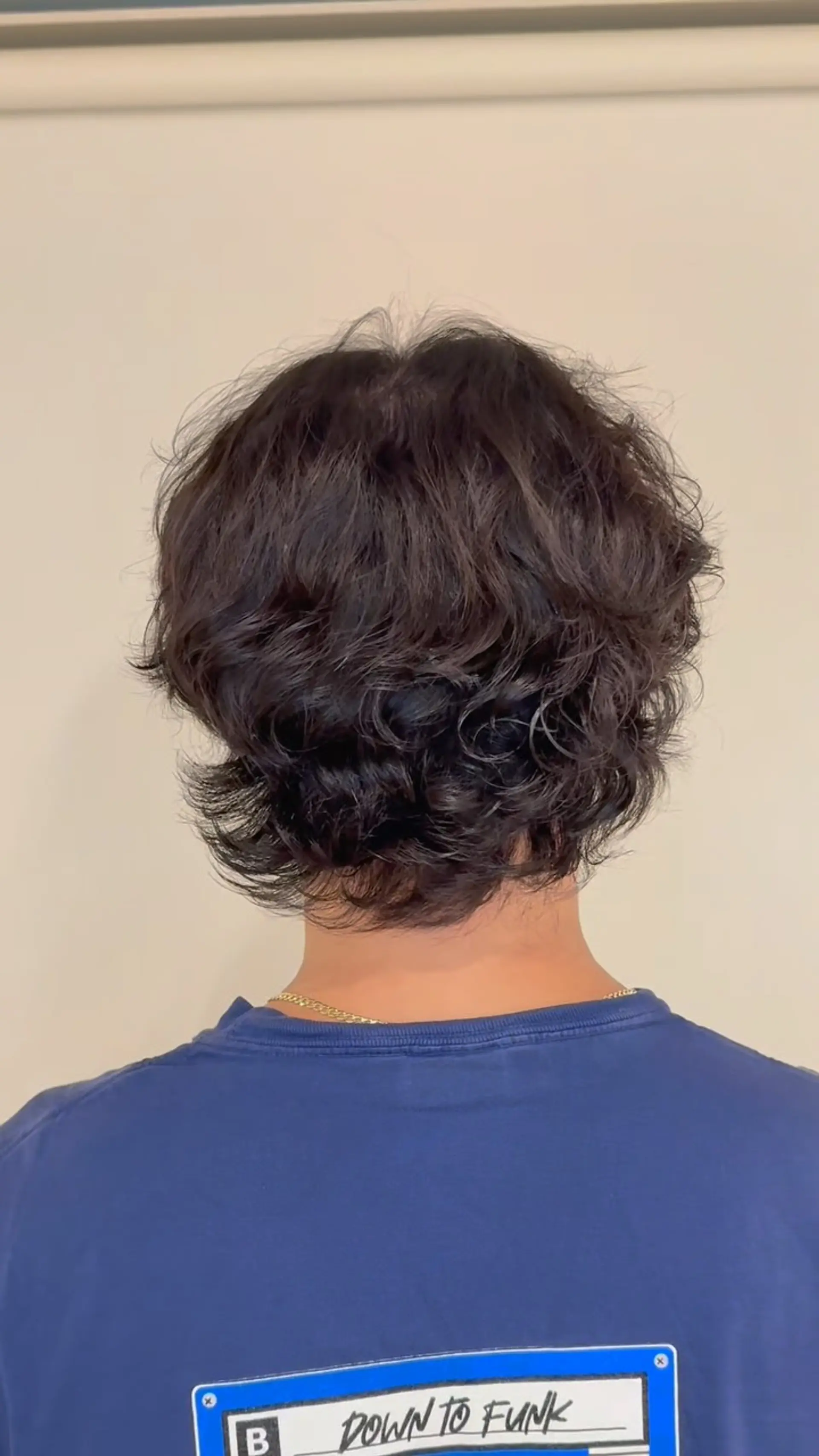 A neck-length textured haircut featuring soft, loose waves and layered volume through the crown and nape. 1