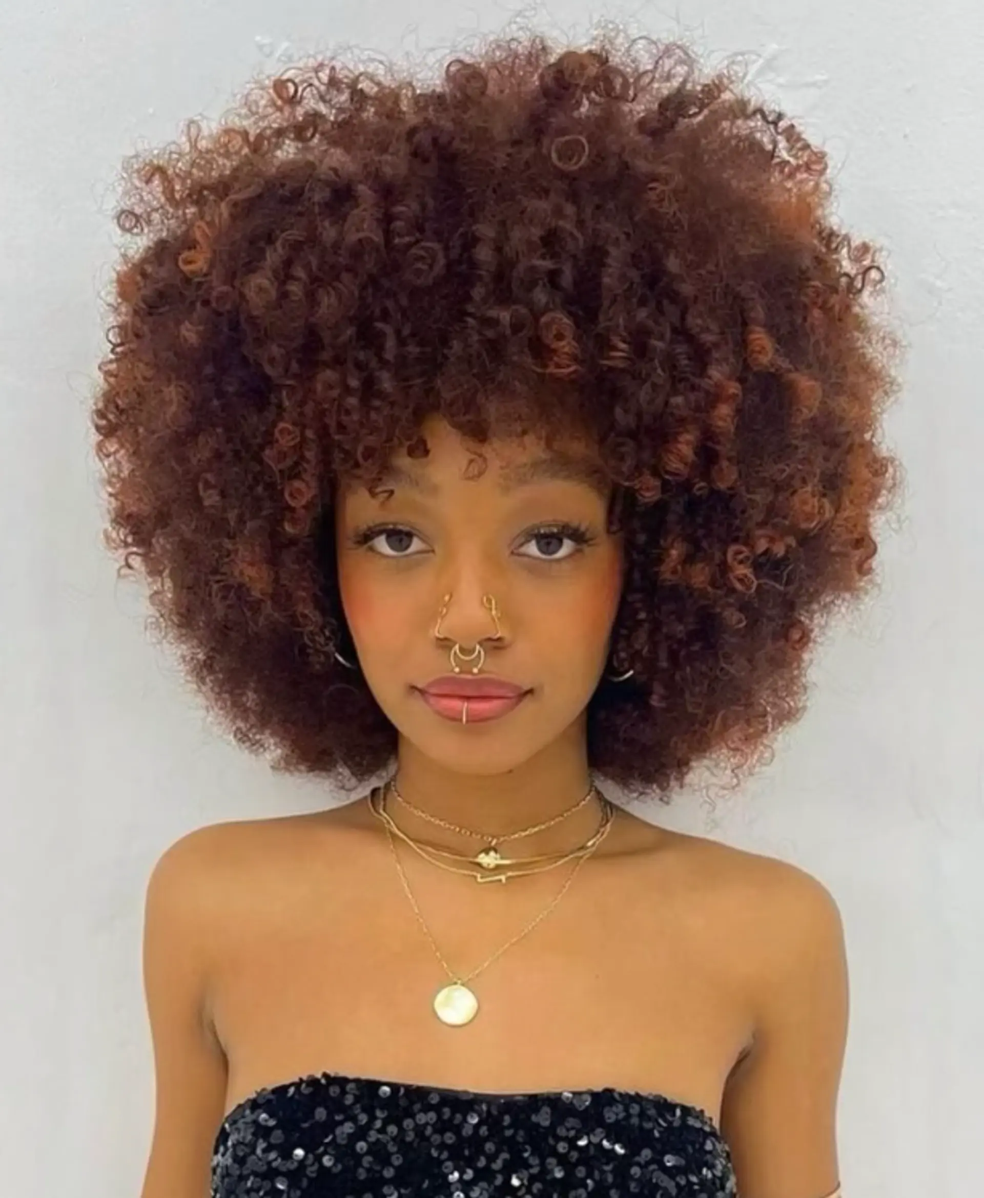 A voluminous, round afro with defined curls. 1