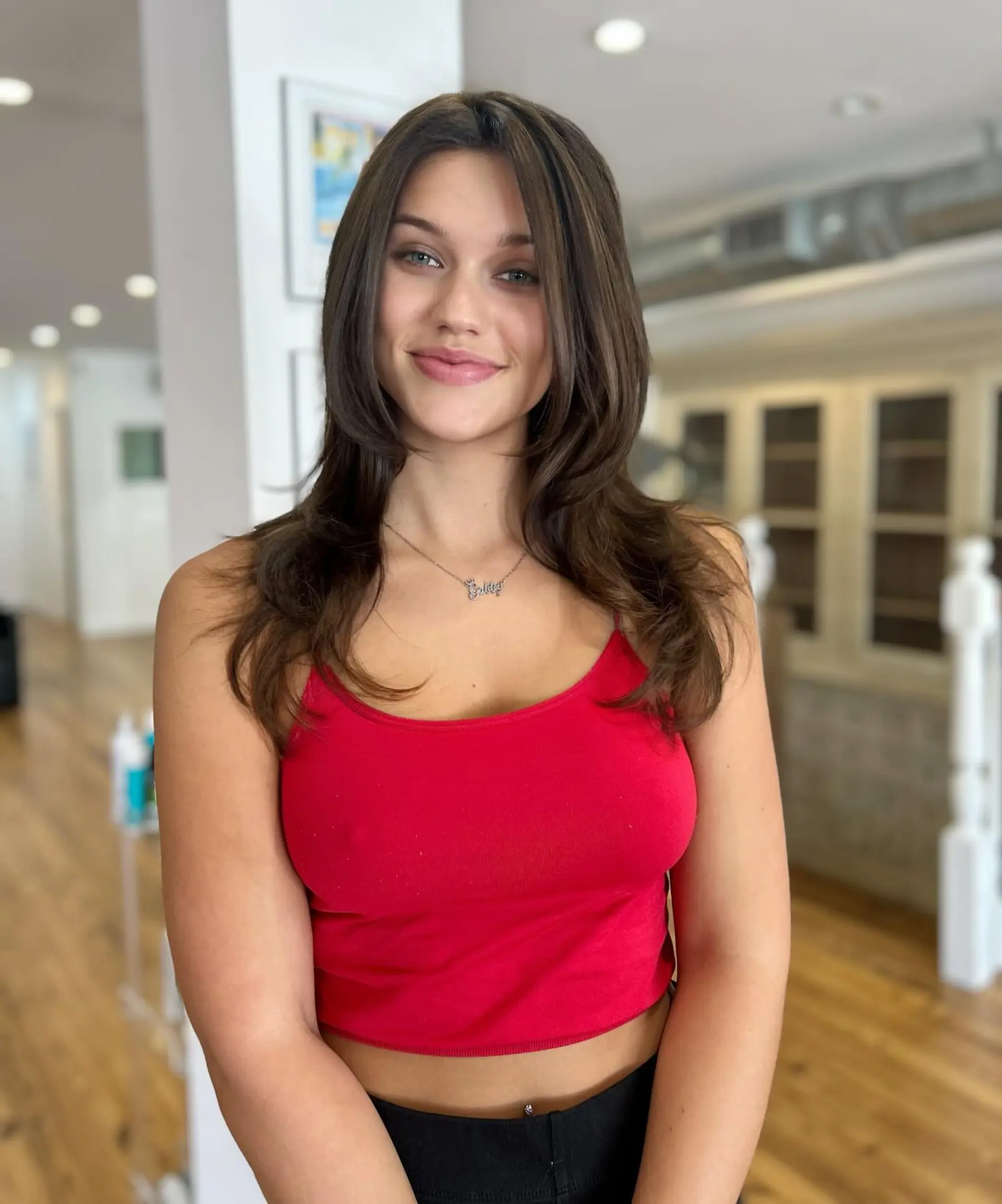 A medium-length layered cut with soft, face-framing layers and a subtle wavy texture. 1