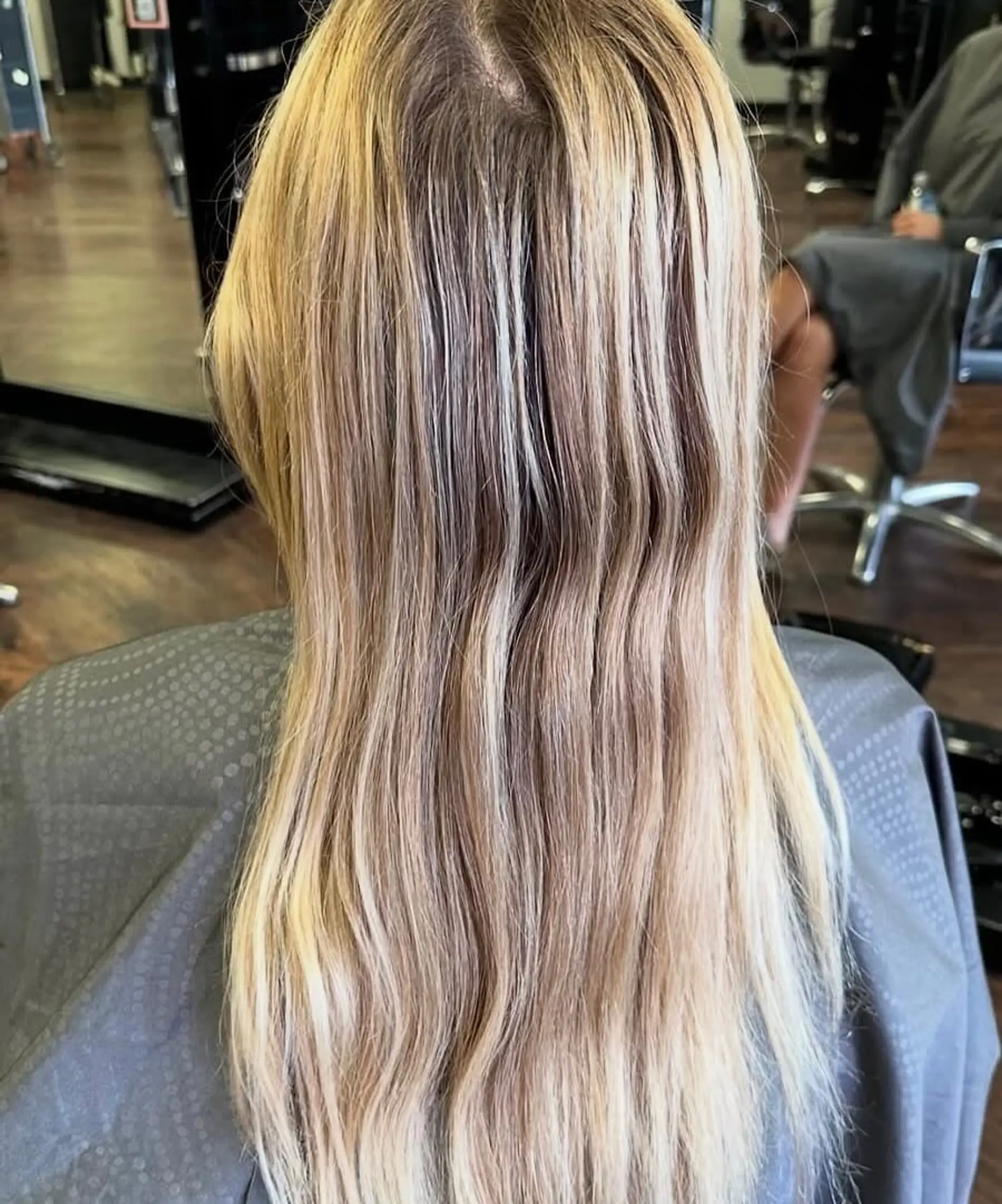 A medium-length layered cut with soft, face-framing layers and a subtle wavy texture. 3