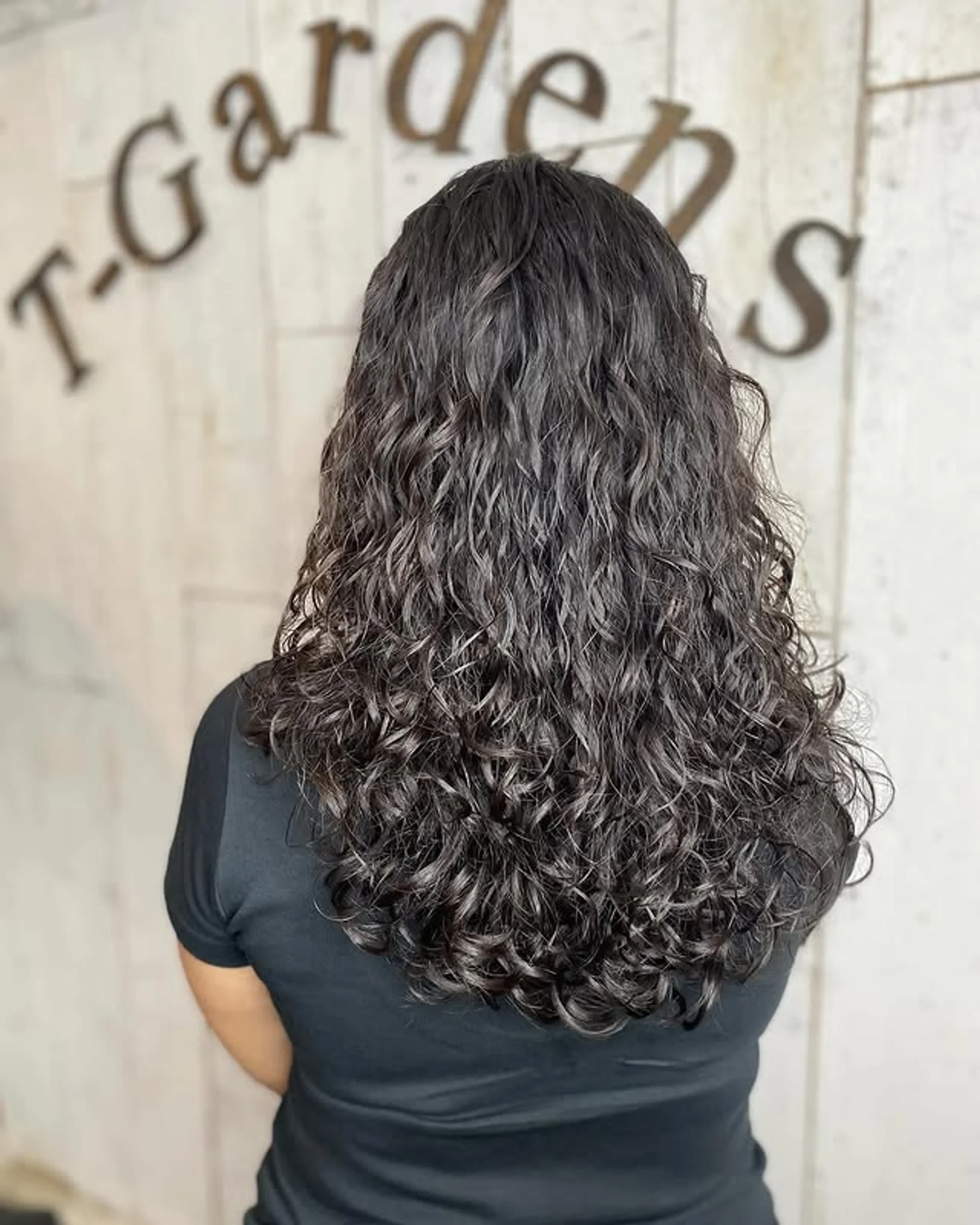 A woman confidently sporting a voluminous Natural Afro Hairstyle, embodying the spirit of self-expression. - Preview 2