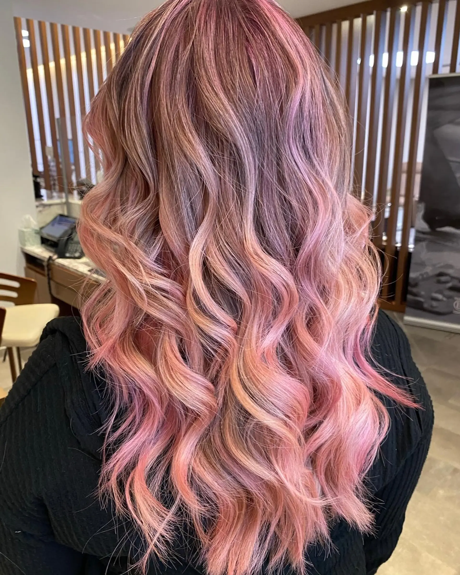 Long wavy hair with a strawberry pink balayage. 2