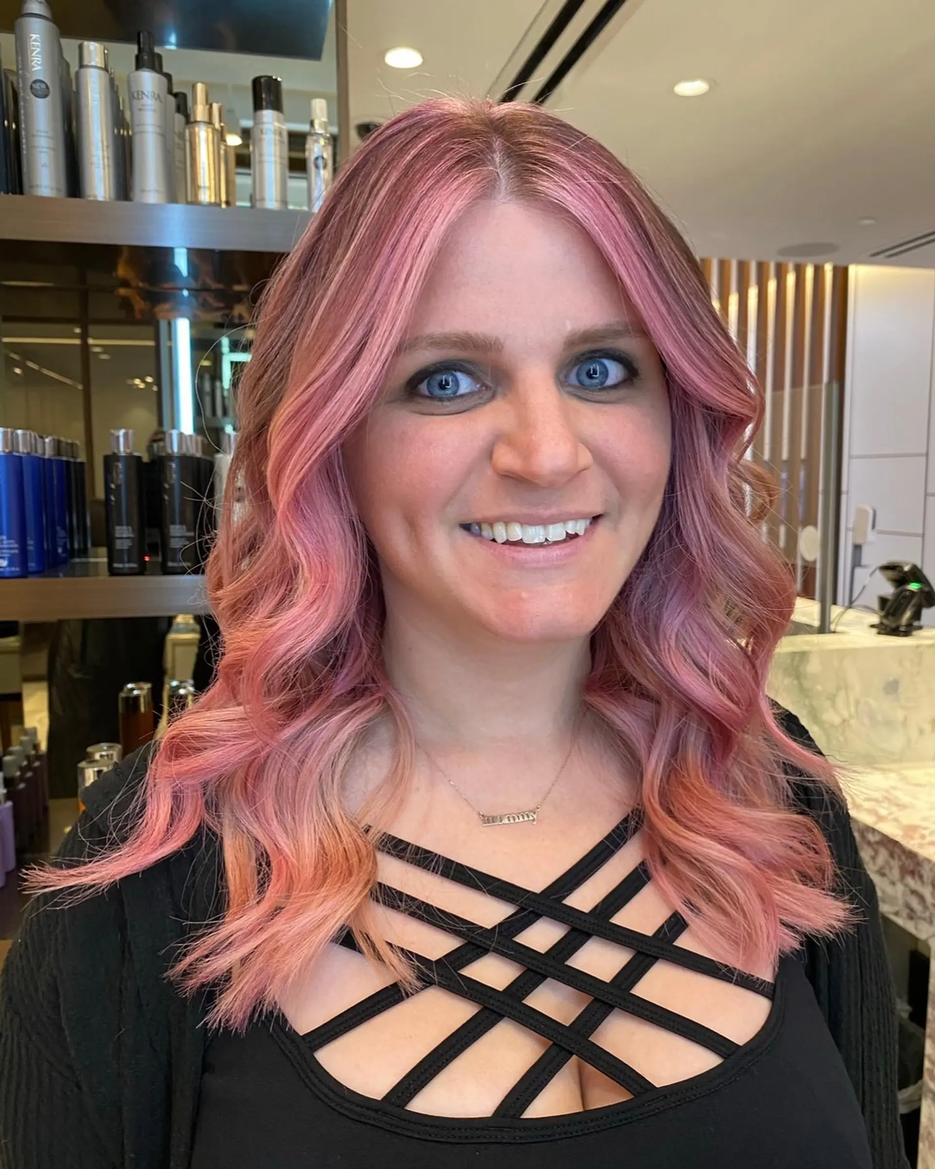 Long wavy hair with a strawberry pink balayage. 3