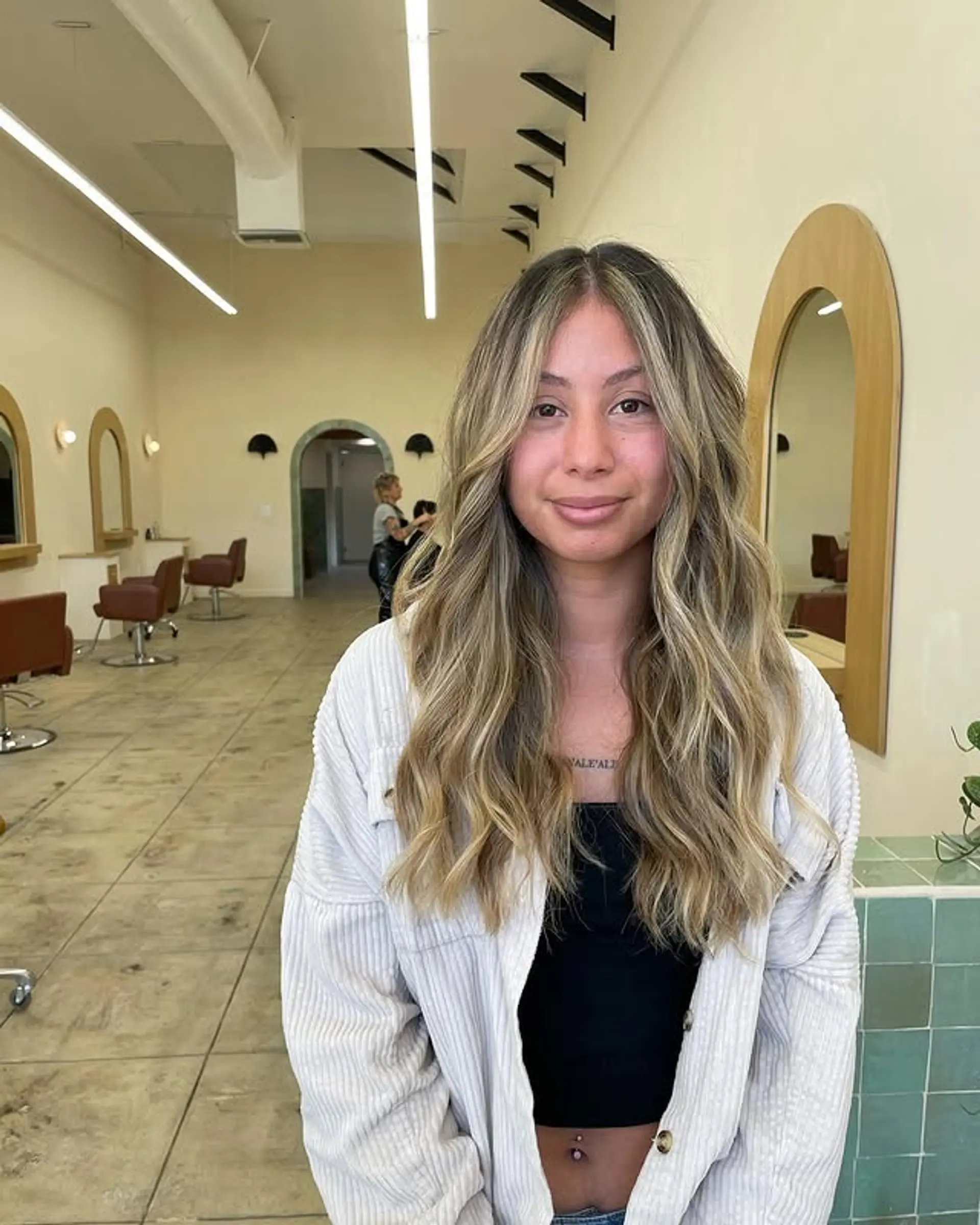 Long, wavy hair with a blonde balayage for a beachy, sun-kissed look. 1