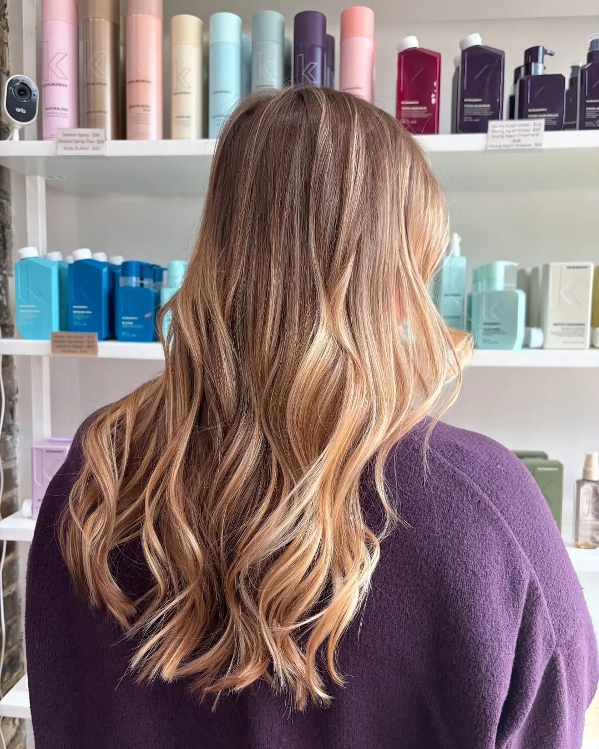 Long, wavy hair styled with a gorgeous golden balayage, showcasing seamless transitions from natural roots to bright, dimensional blonde ends for a sun-kissed effect. 1