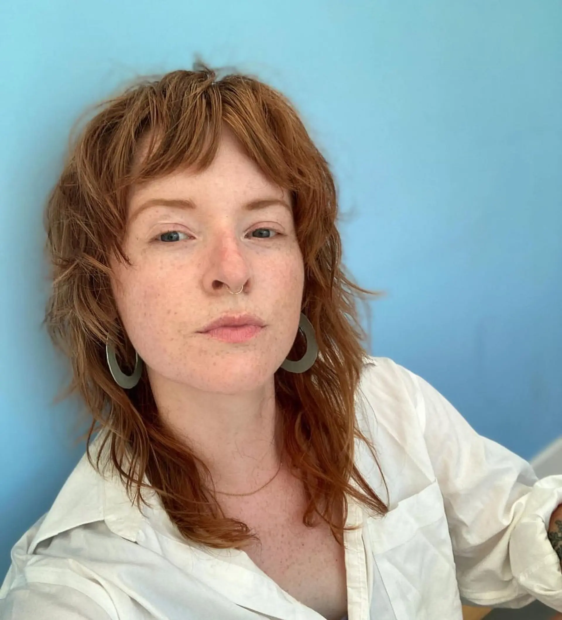 A modern take on the classic mullet with a shaggy texture and short baby bangs. 1