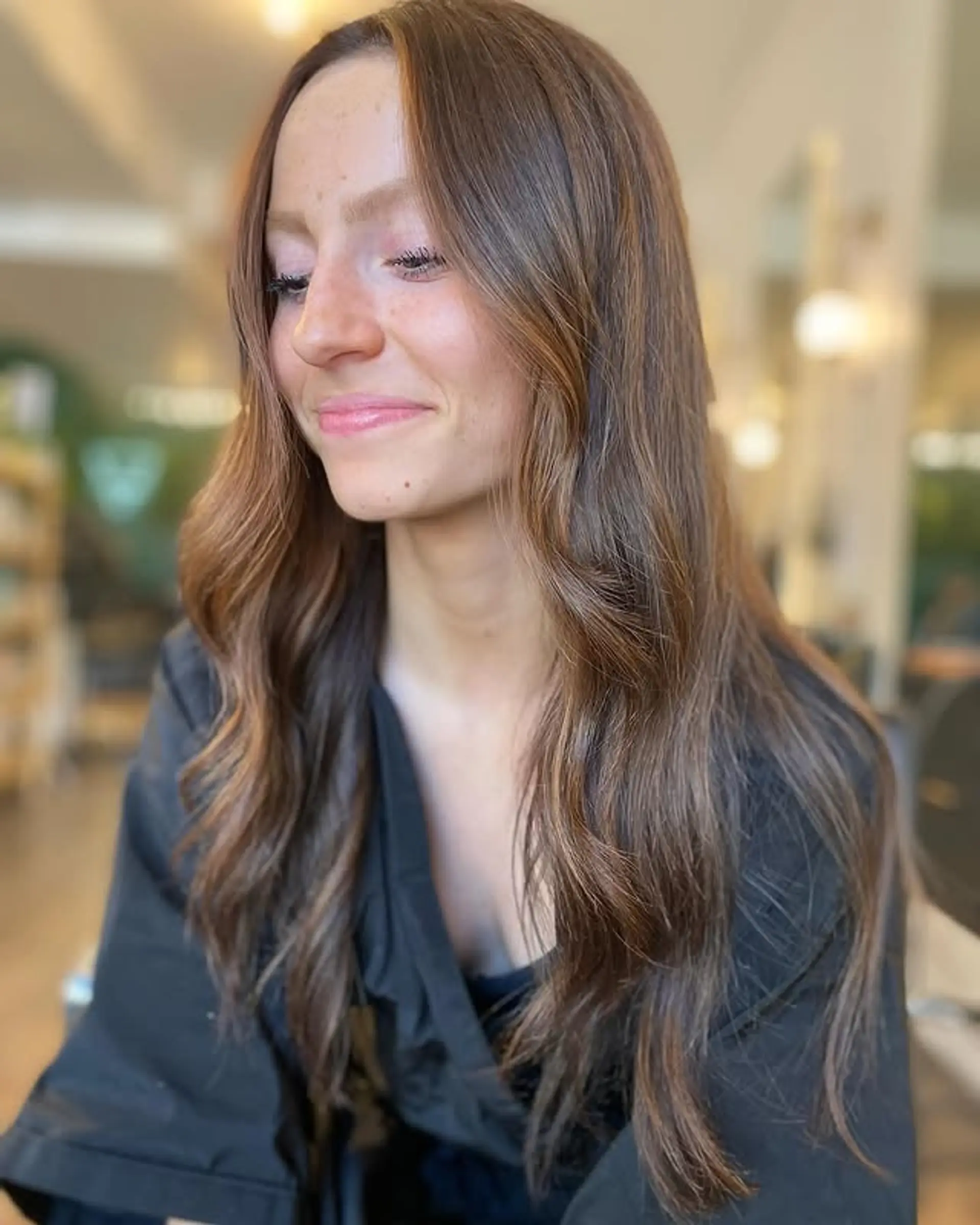 Long, wavy bronzed brown hair with blonde balayage highlights and subtle layers. 1