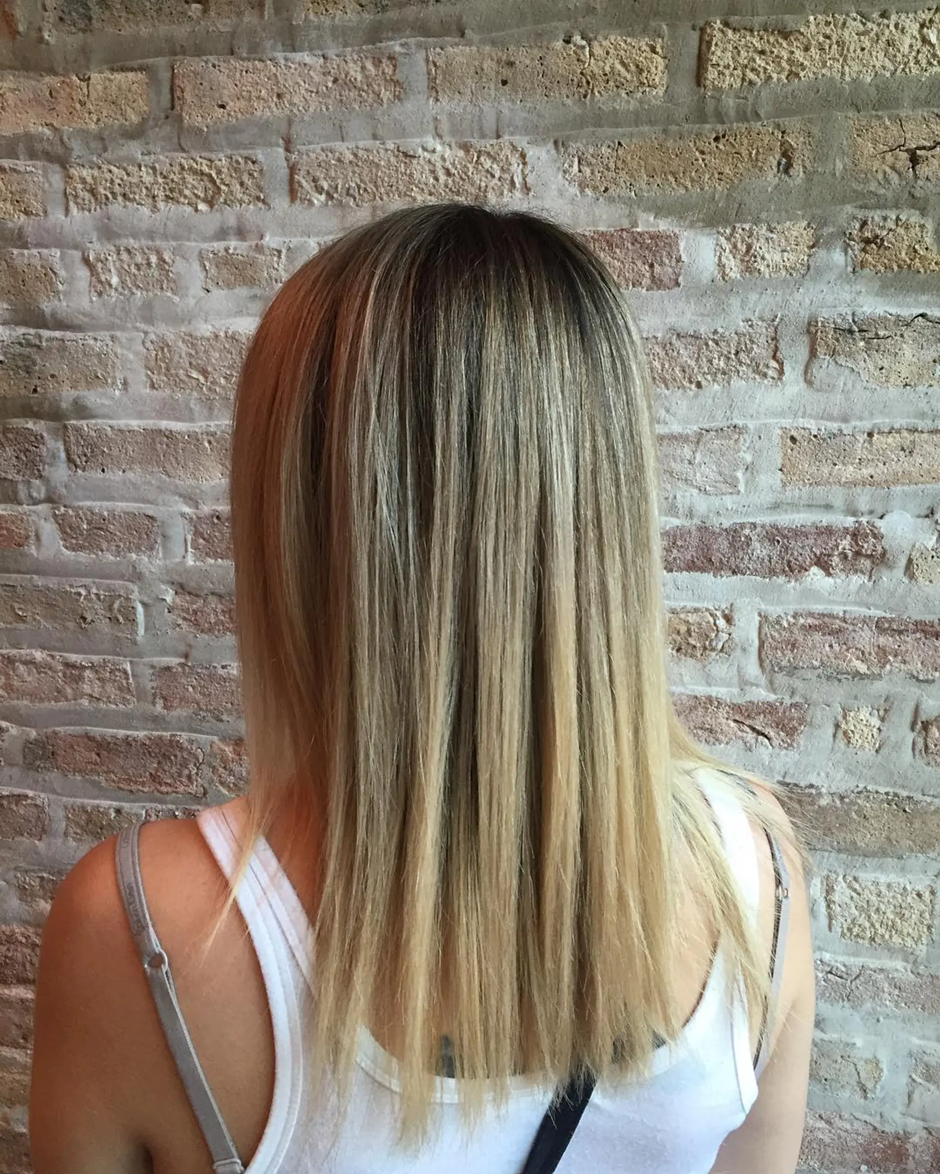 A medium length hairstyle with a sunkissed blonde balayage and ombre. 1