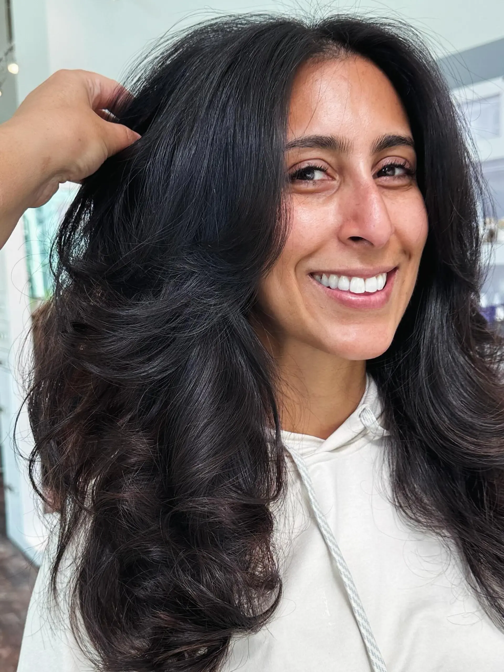 A long and layered haircut with lots of volume. 1