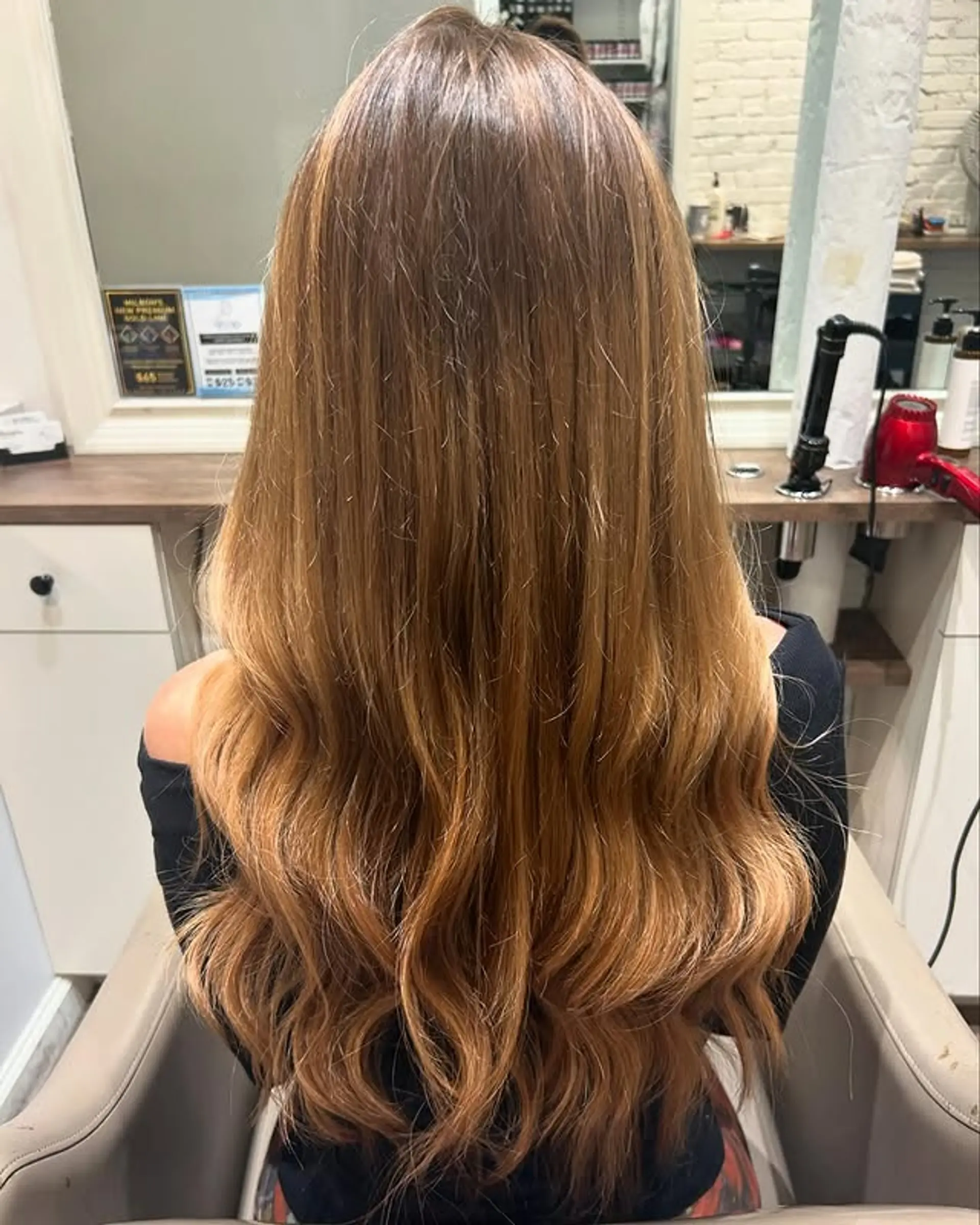 Long, wavy hair with soft romantic waves and a golden blonde balayage. 1