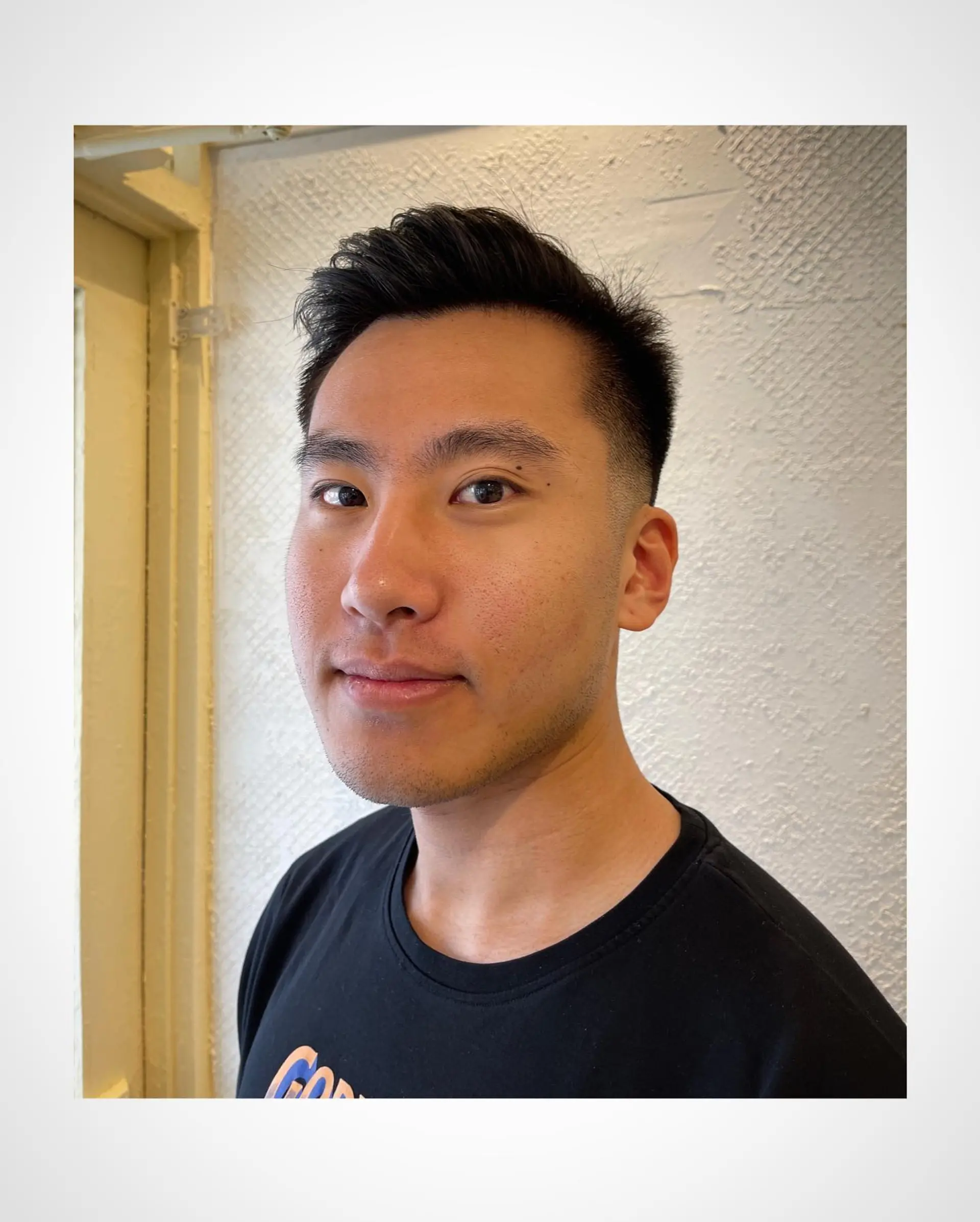 A sharp men's haircut featuring clean tapered sides and a textured, slightly lifted top. 1