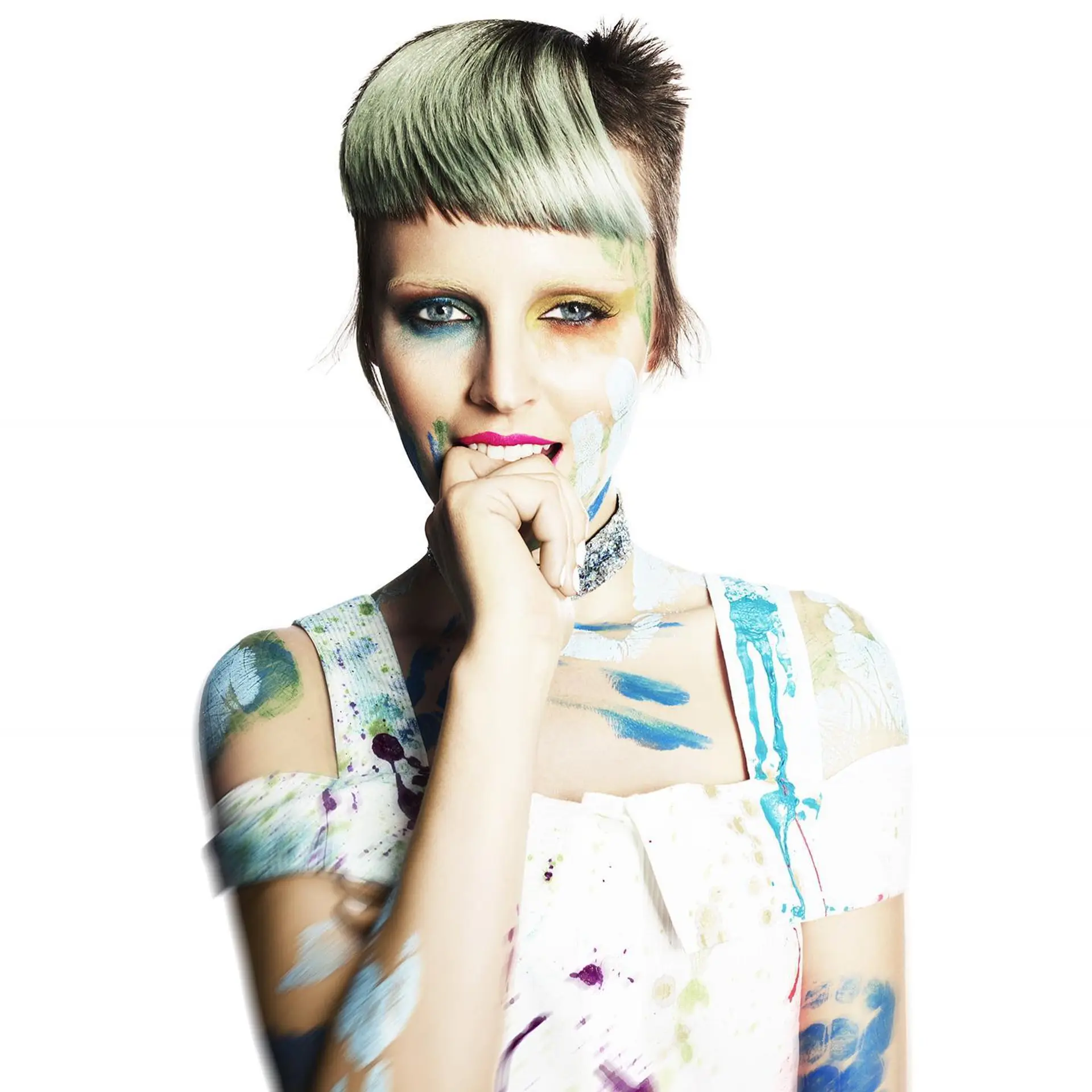 An edgy, editorial short pixie cut featuring blunt asymmetrical micro bangs dyed in a pale mint green hue. 1