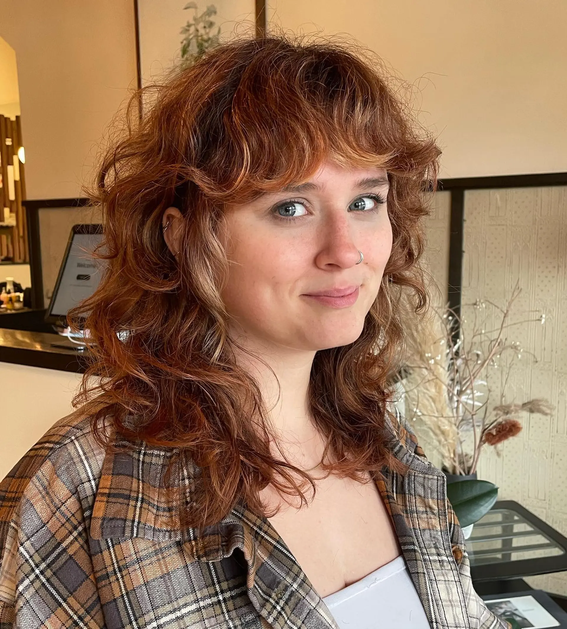 A modern, shaggy mullet with choppy layers and baby bangs. 1