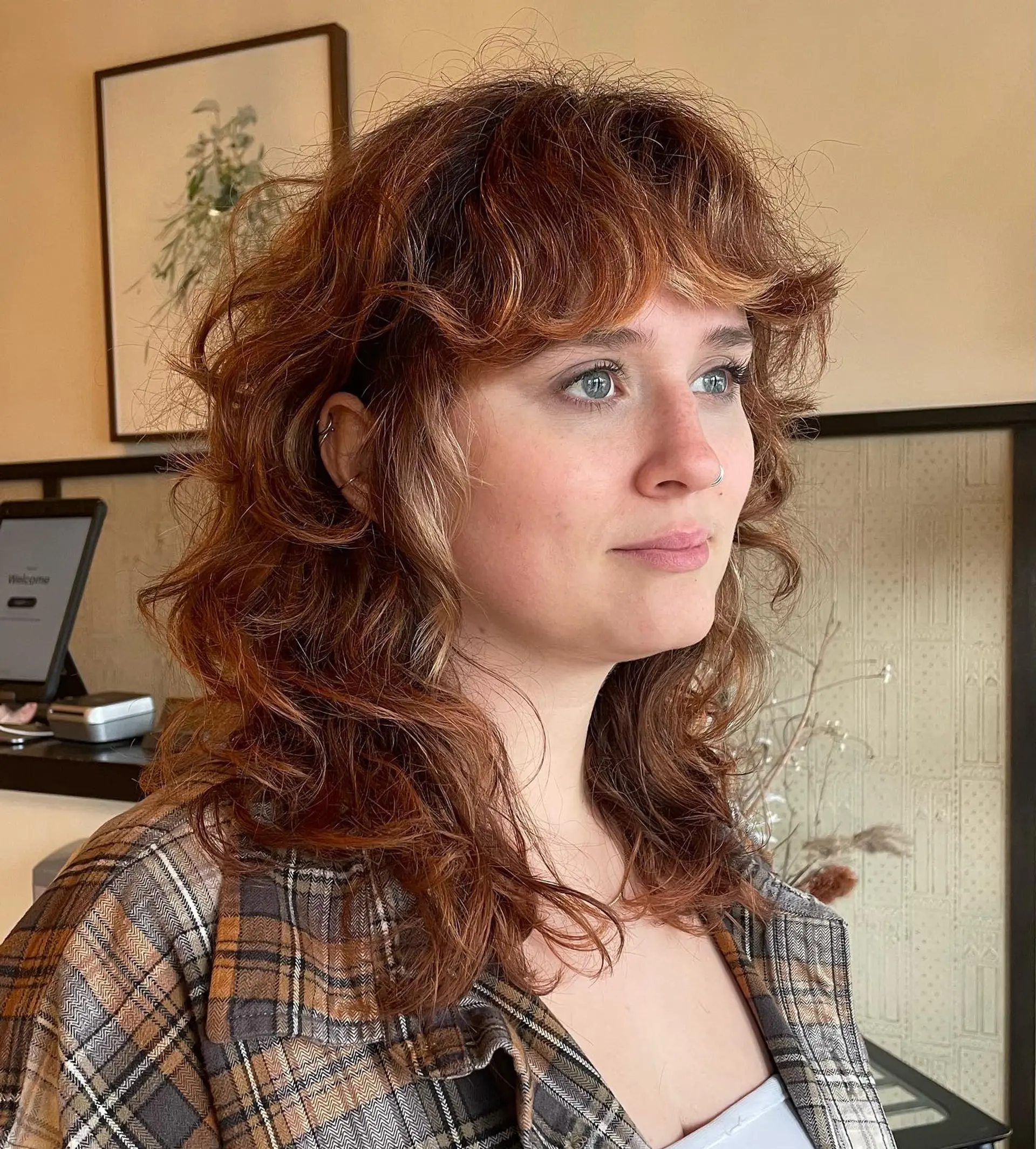 A modern, shaggy mullet with choppy layers and baby bangs. 2