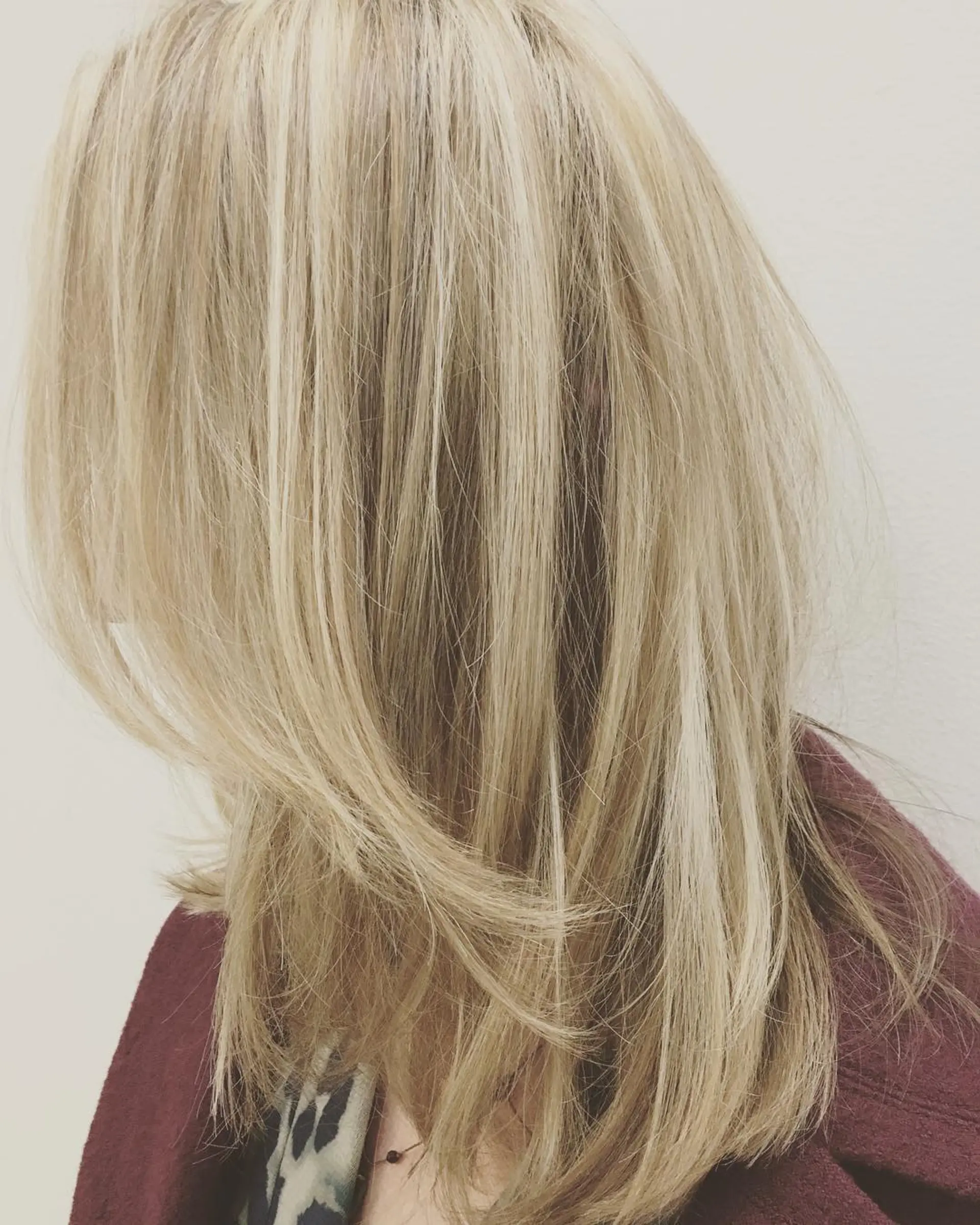 Medium-length blonde hair featuring dimensional balayage highlights and soft face-framing layers. 1