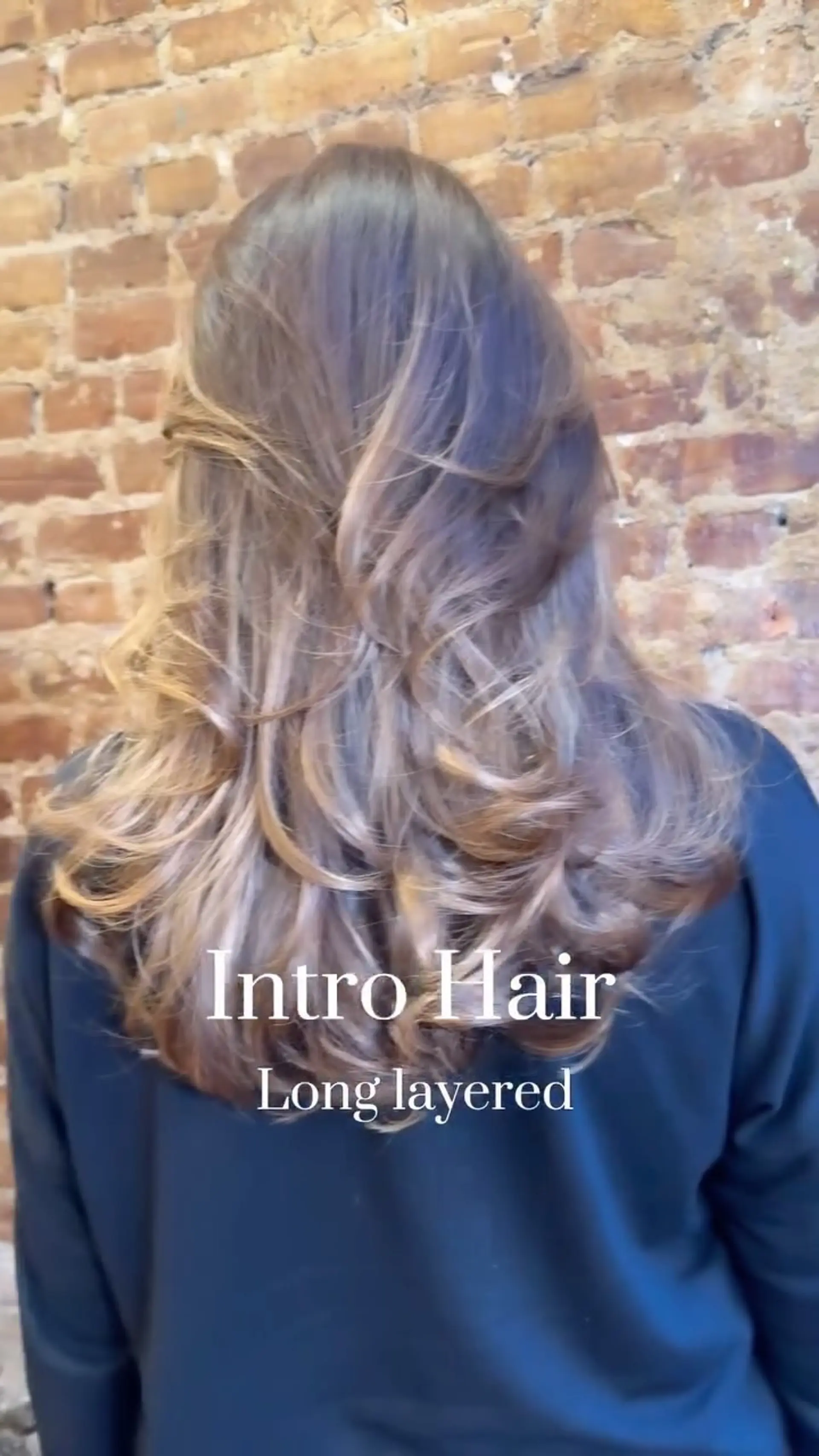 A long, layered haircut styled into a full, bouncy blowout with curled, flipped ends. 1
