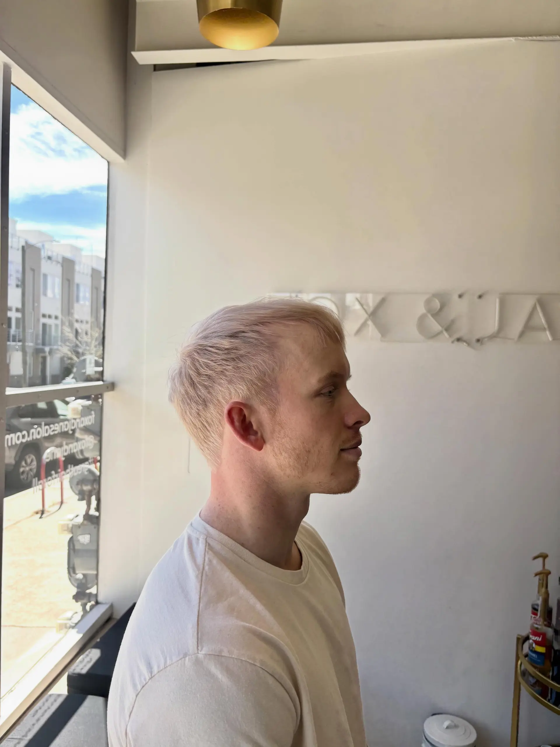 A short, textured crop cut paired with an all-over pale platinum blonde bleach and tone. 1