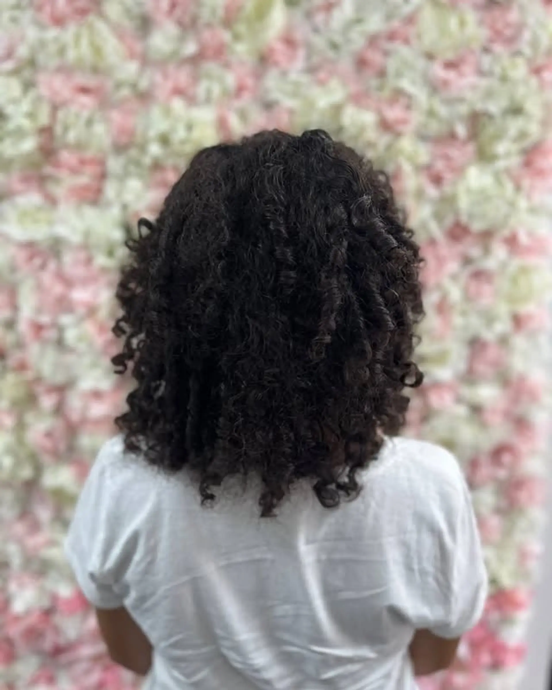 A classic bob haircut designed for curly hair, falling to a medium length. 1