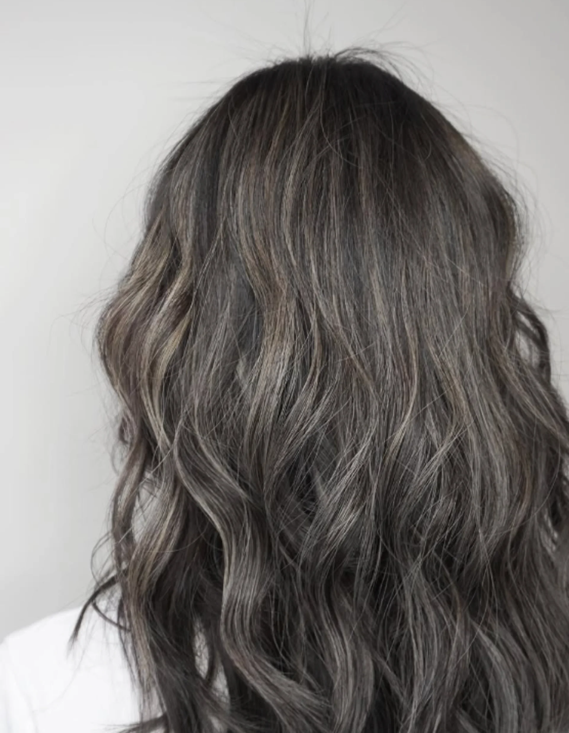 Elegant silver waterfall hair showcasing natural gray blending and straight architectural cutting - Preview 2