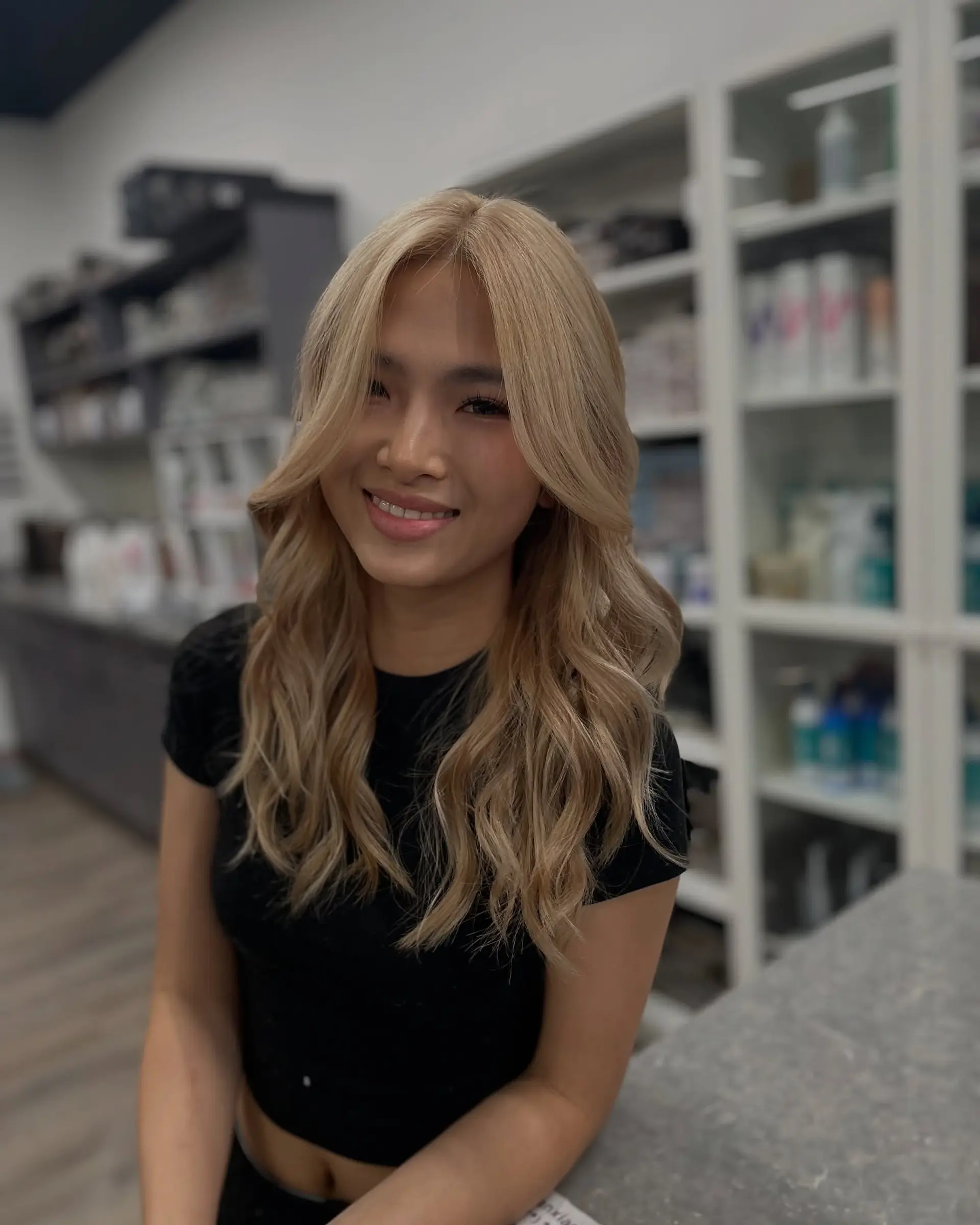 Long, layered blonde hair styled into relaxed beachy waves. 2