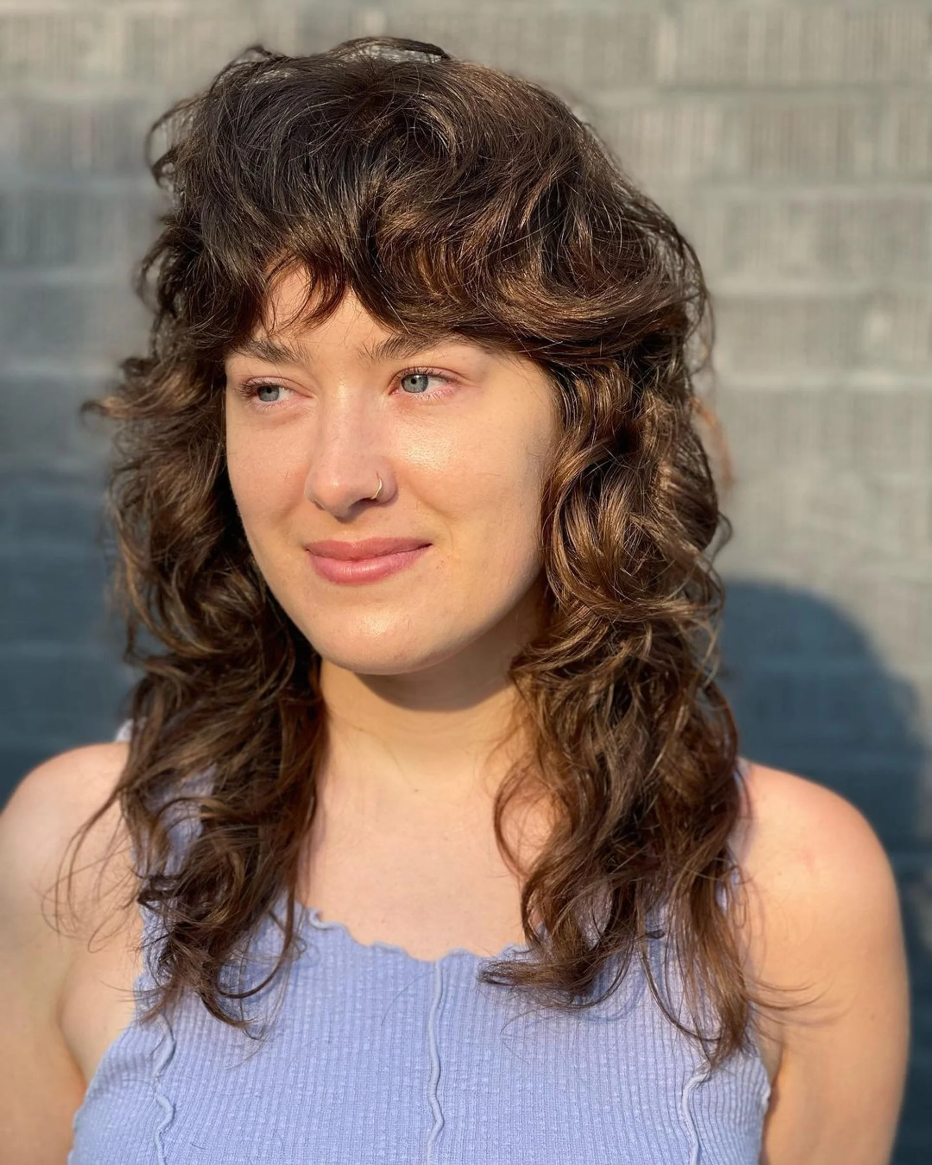 A model with long, wavy fiery red and orange hair, representing a key forward-thinking hair trend for 2026. - Preview 2