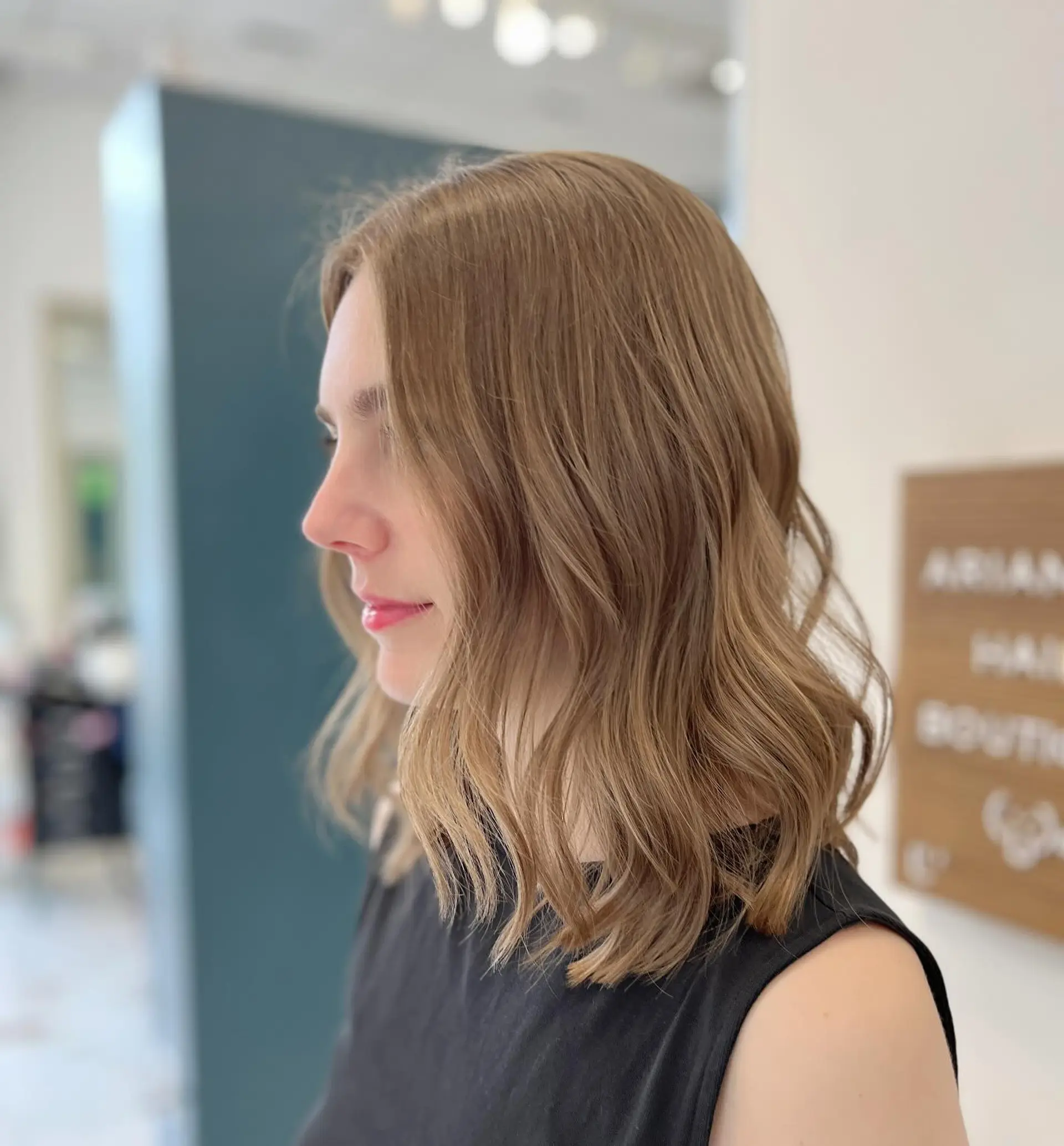 A shoulder-length layered lob styled with soft, undone waves in a cool-toned light brown shade. 1