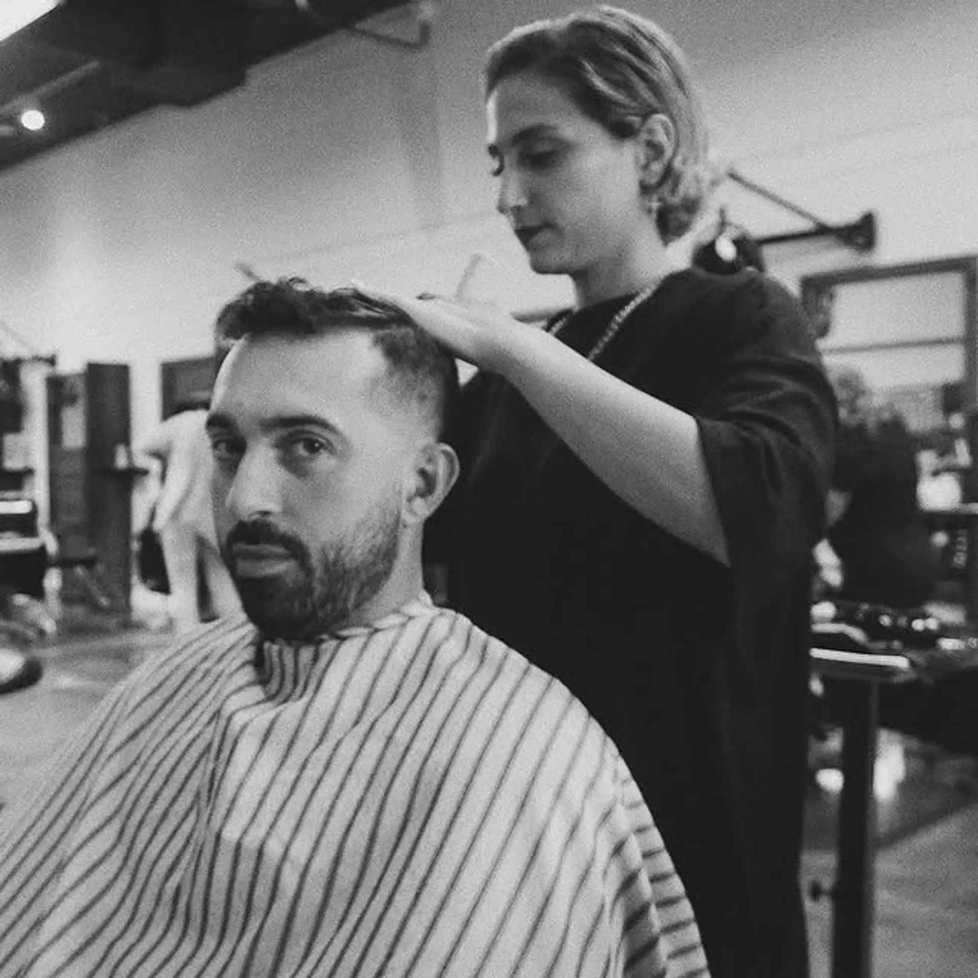 A stylish taper fade with a textured top. The sides are faded short, while the top is left slightly longer and textured for a modern look. 1