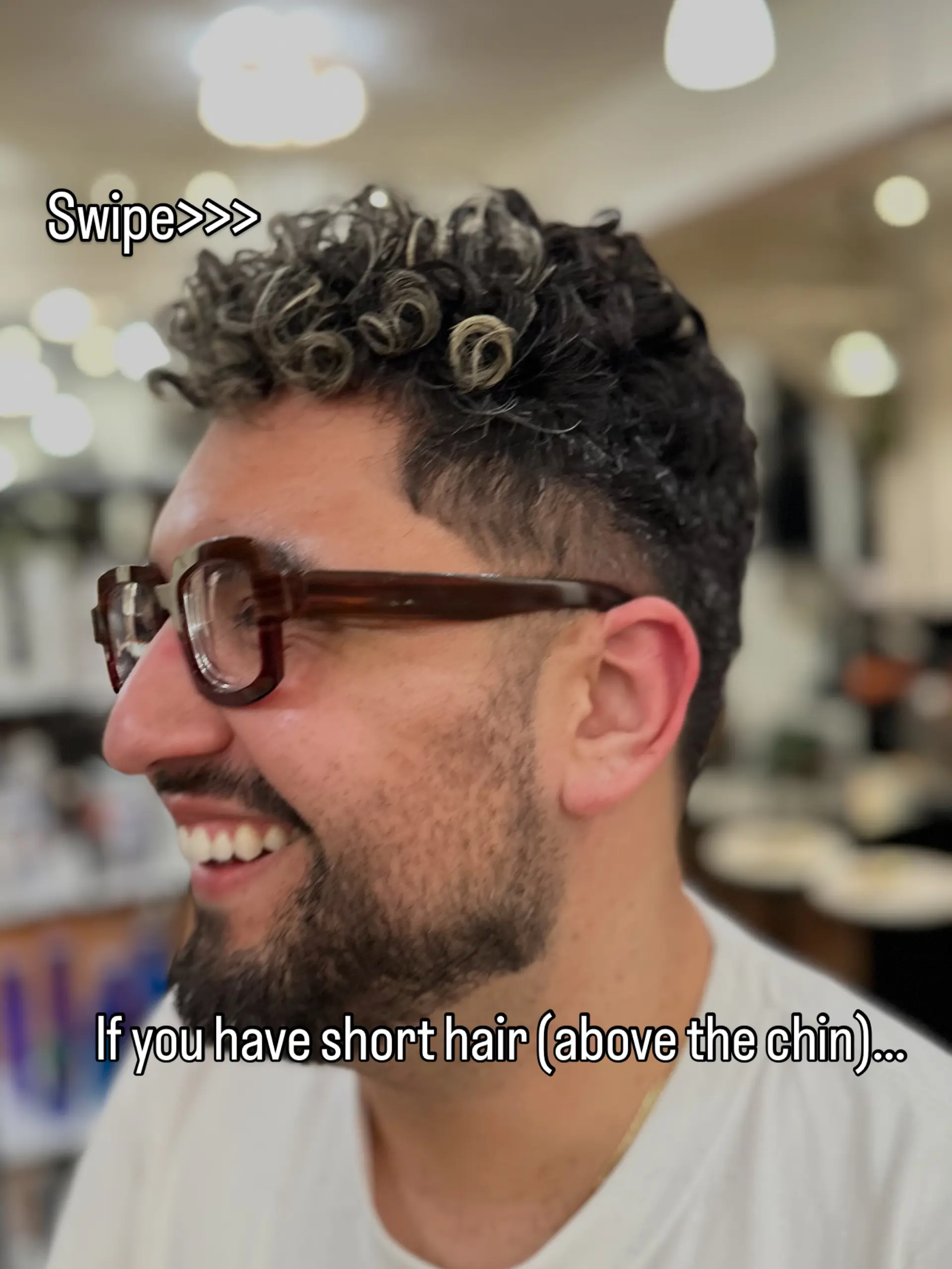 Short textured curly crop featuring clean tapered sides and defined blonde-highlighted ringlets on top. 1